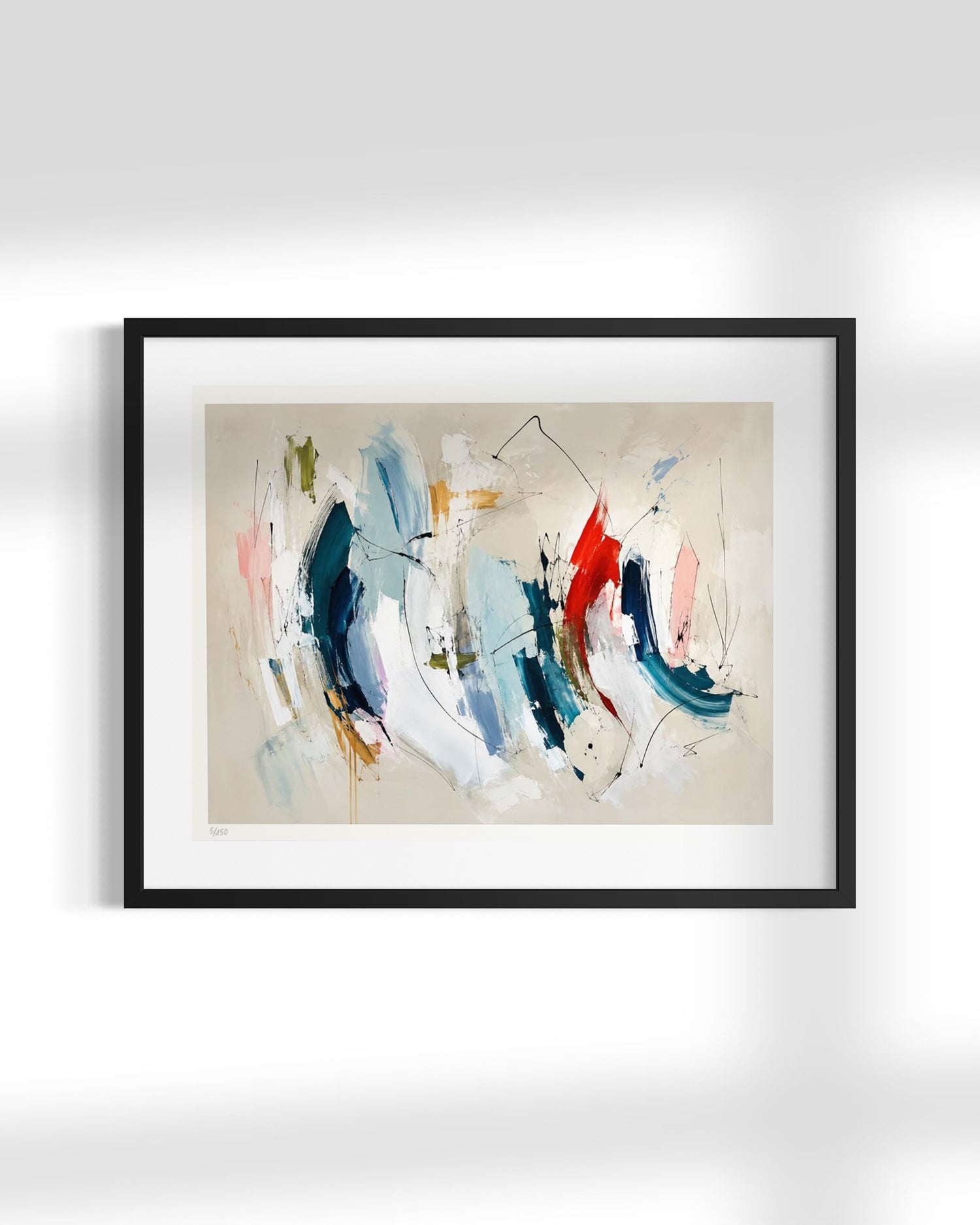 Framed abstract wall art hanging on a light gray wall. The artwork features broad brushstrokes in blue, white, beige, red, and pink on a warm off-white background, enclosed in a black frame with a white mat.