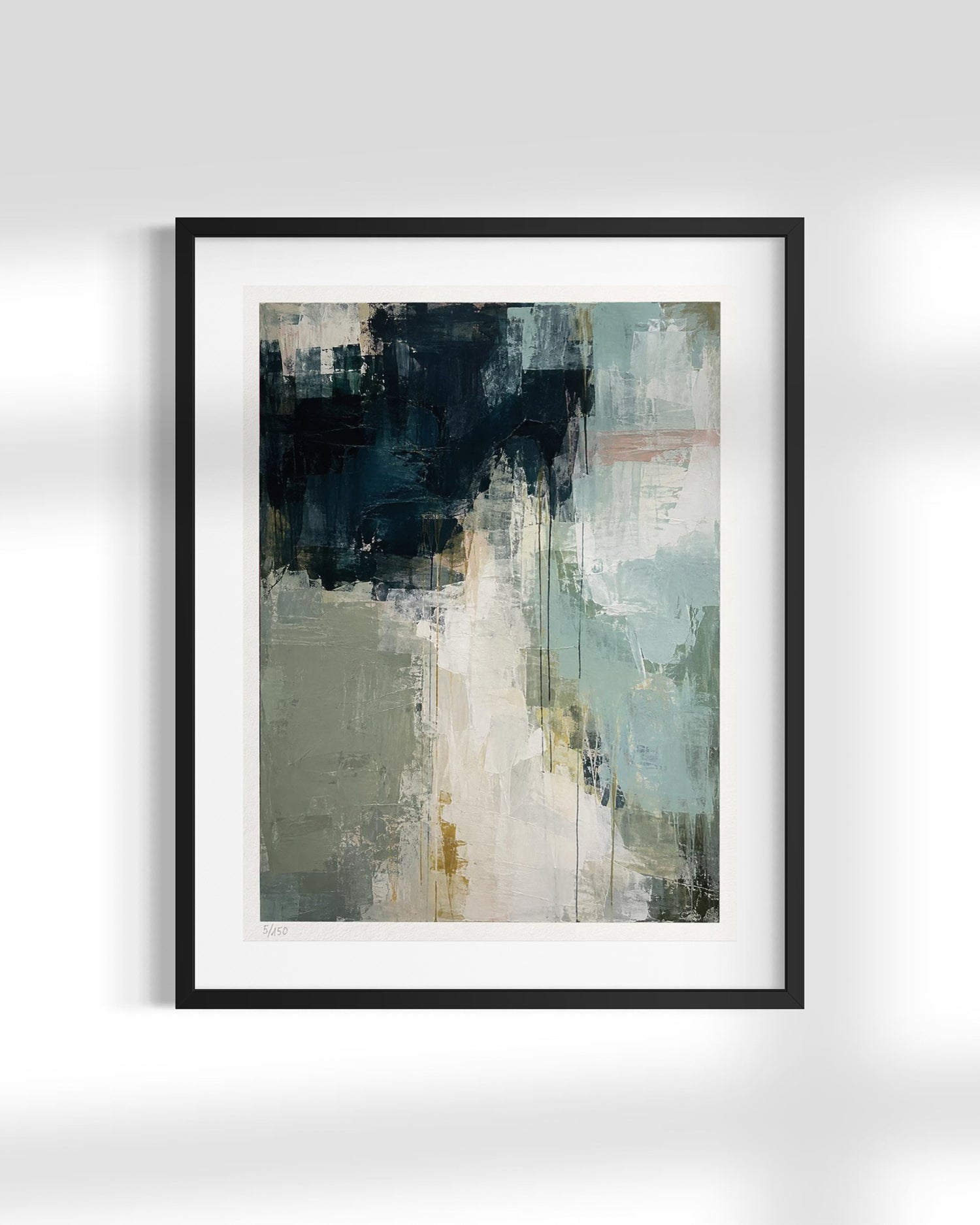 A framed abstract art print featuring a textured composition of navy, sage green, cream, and light blue brushstrokes, presented in a black frame with a white mat against a light gray wall.