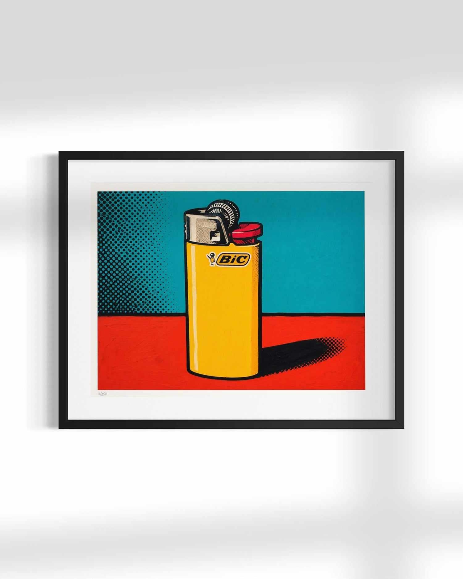 A framed pop-art style print featuring a yellow BIC lighter on a red surface against a teal and black halftone background, displayed against a light gray wall.