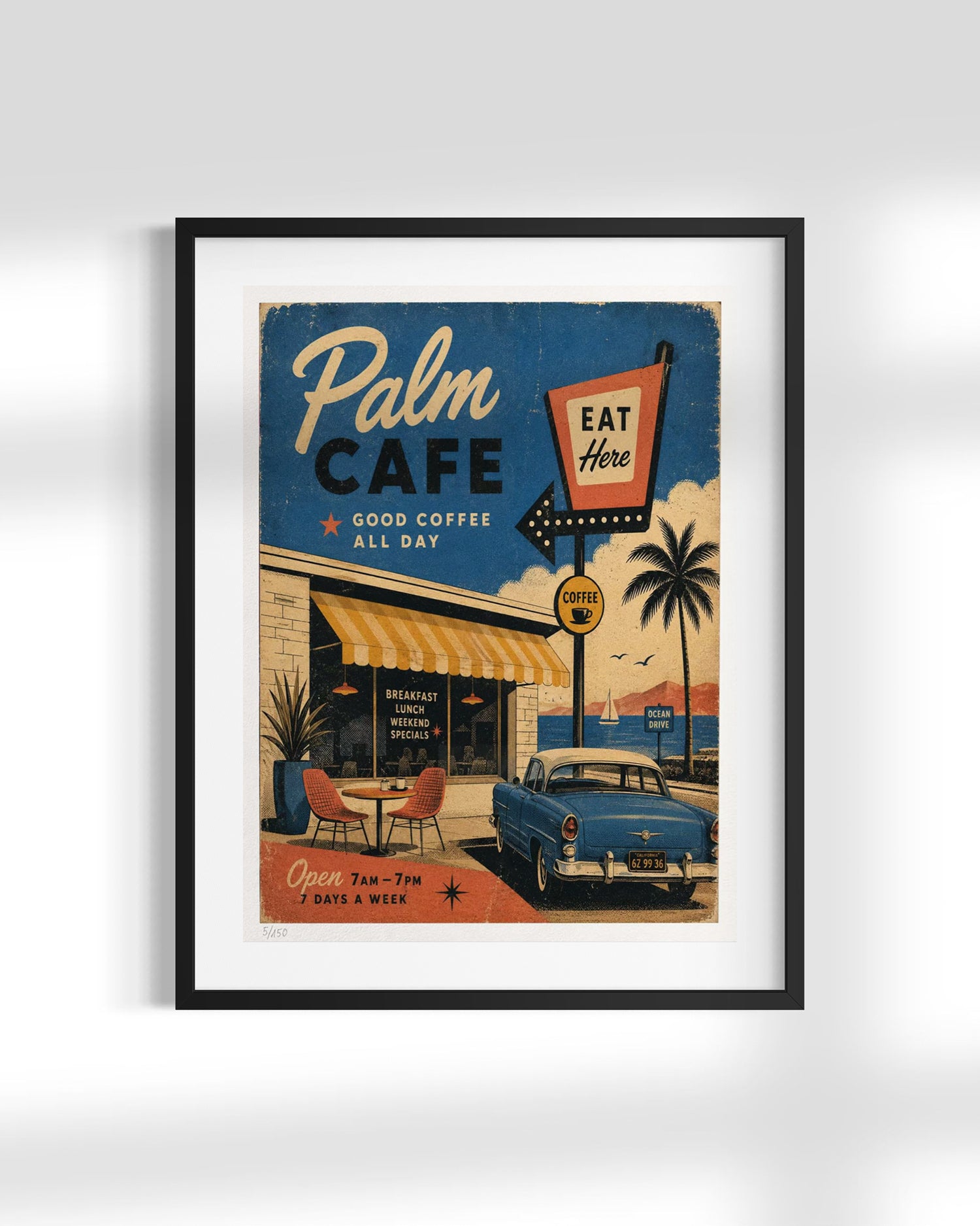 A framed vintage-style cafe poster reading 'Palm Cafe' with retro typography, palm trees, a blue car, and a black frame, shown against a light gray wall.