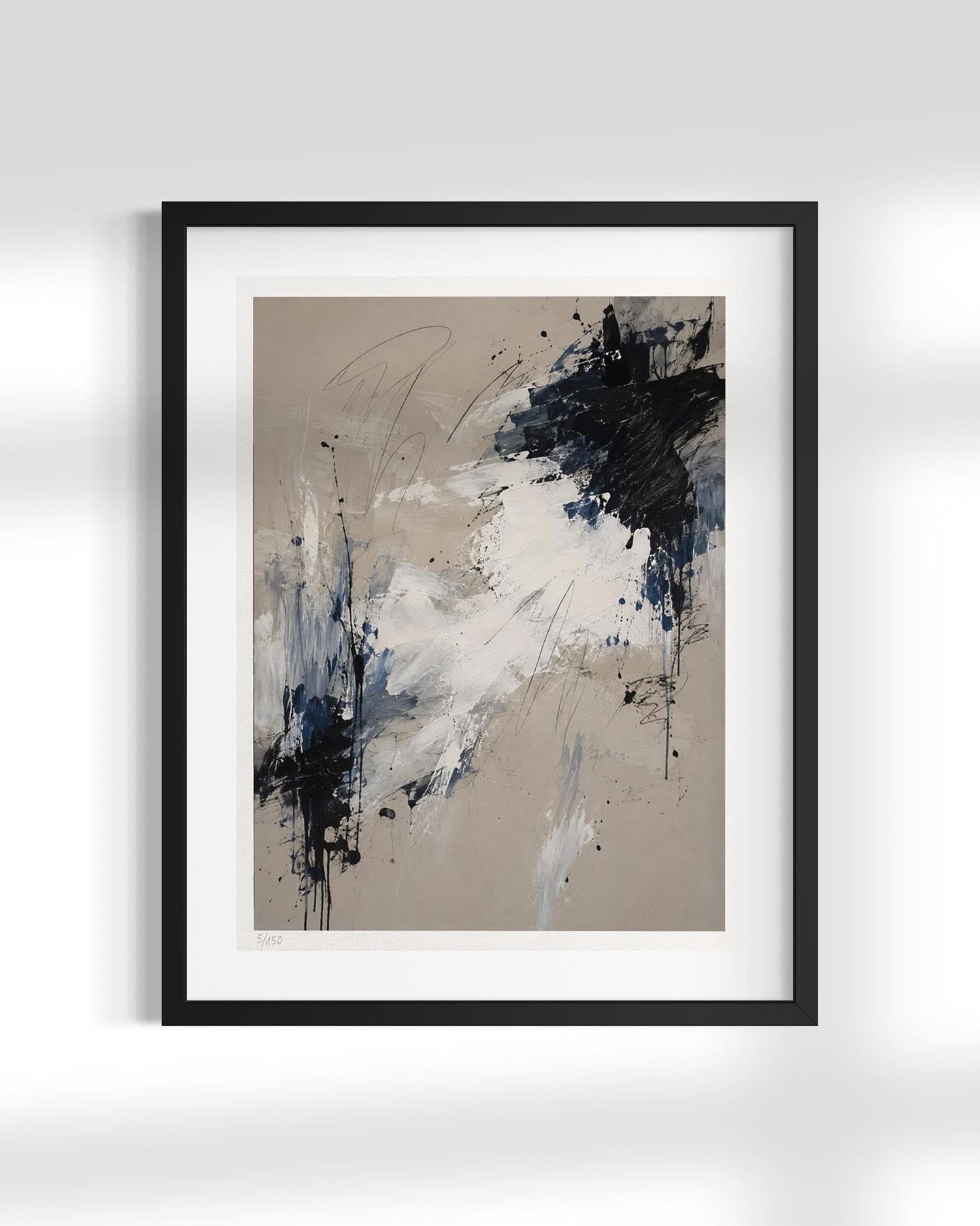 A framed abstract art print featuring a modern composition of black, navy, white, and beige paint splatters and brushstrokes, presented in a black frame with a white mat against a light gray wall.