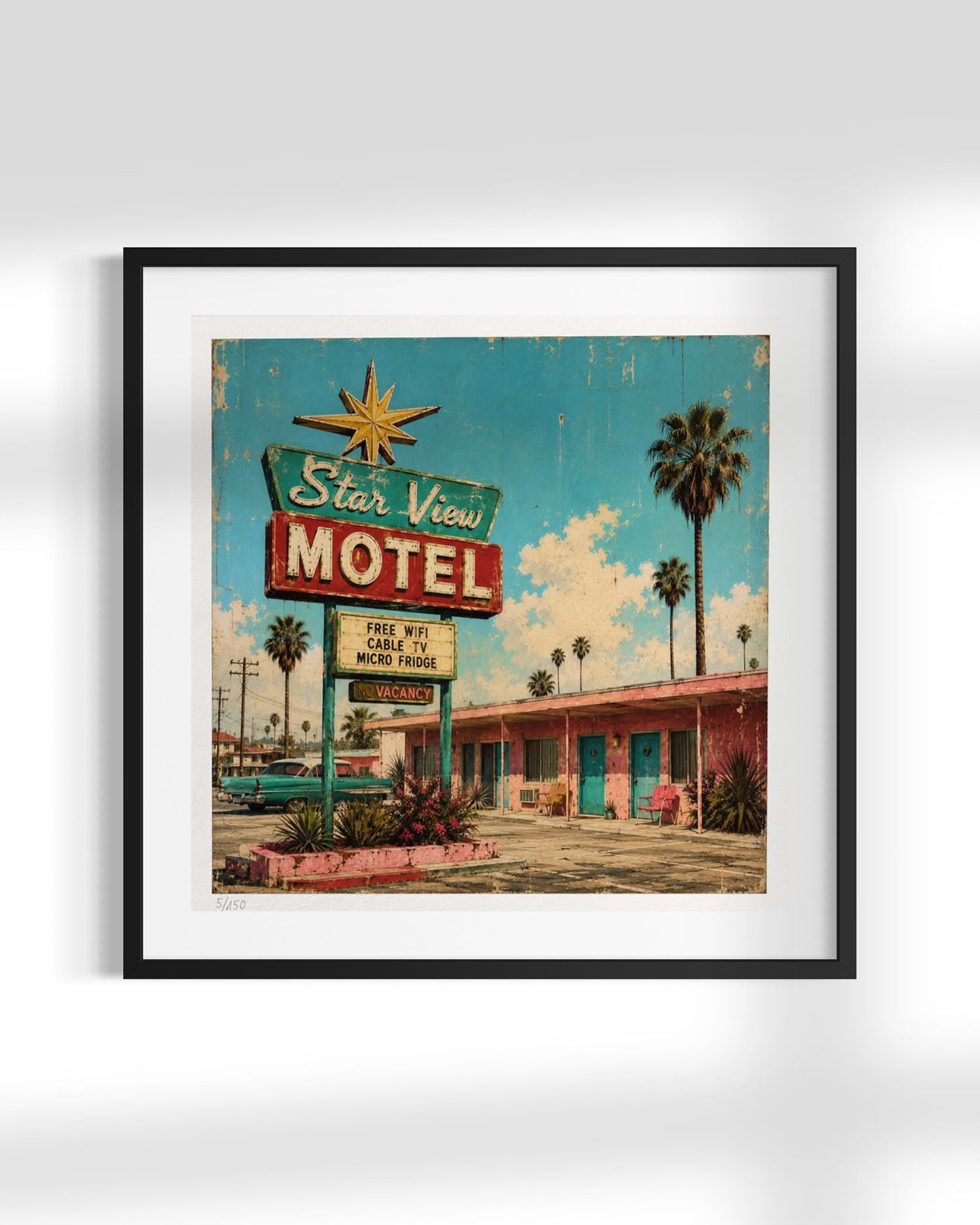 Framed wall art featuring a retro motel sign and building scene, shown hanging against a light gray wall. The artwork has a turquoise sky, palm trees, a large 'Star View Motel' sign, and a motel facade, all enclosed in a black frame with a white mat.