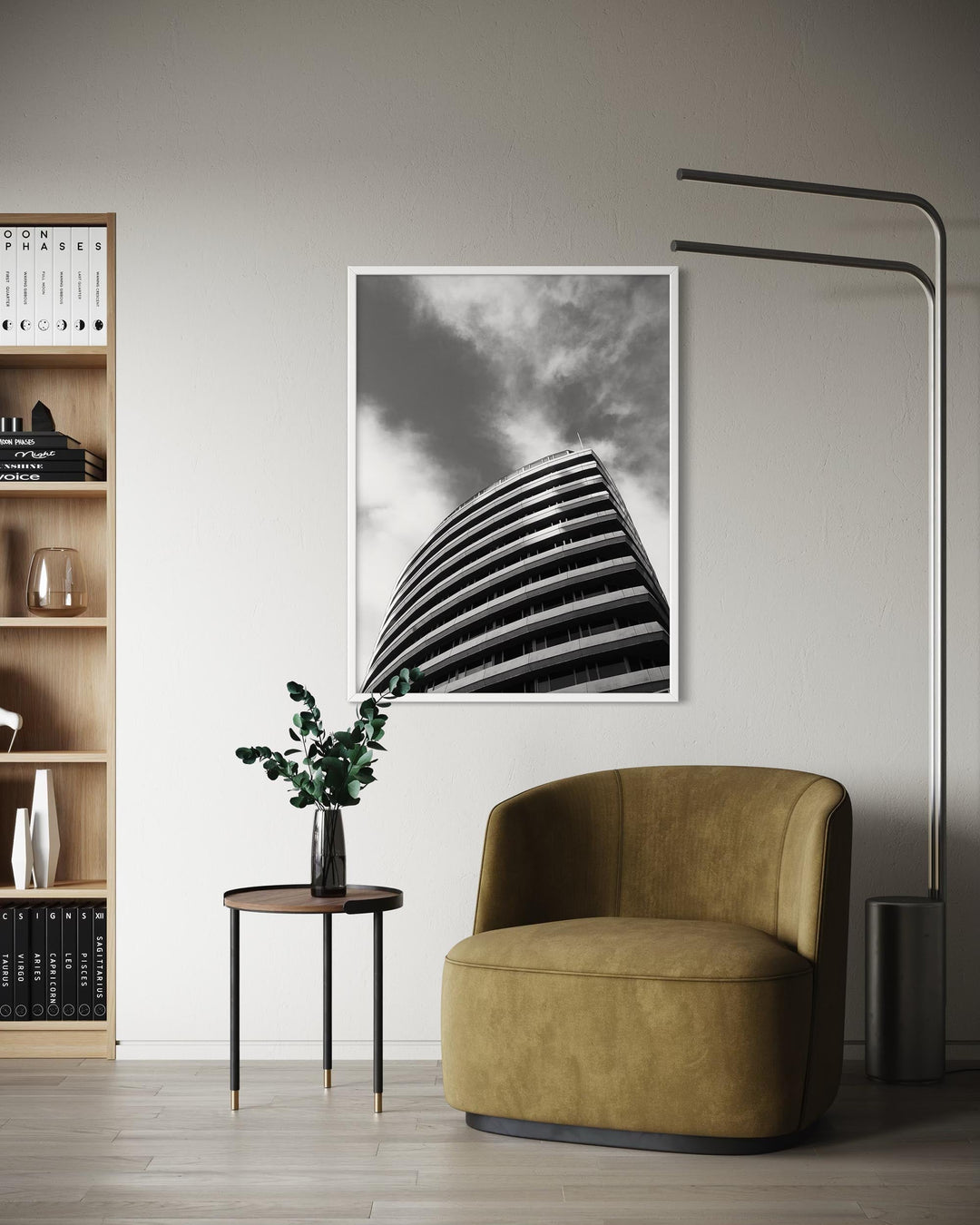 Modern interior with a brown armchair, bookshelf, and abstract art on the wall.
