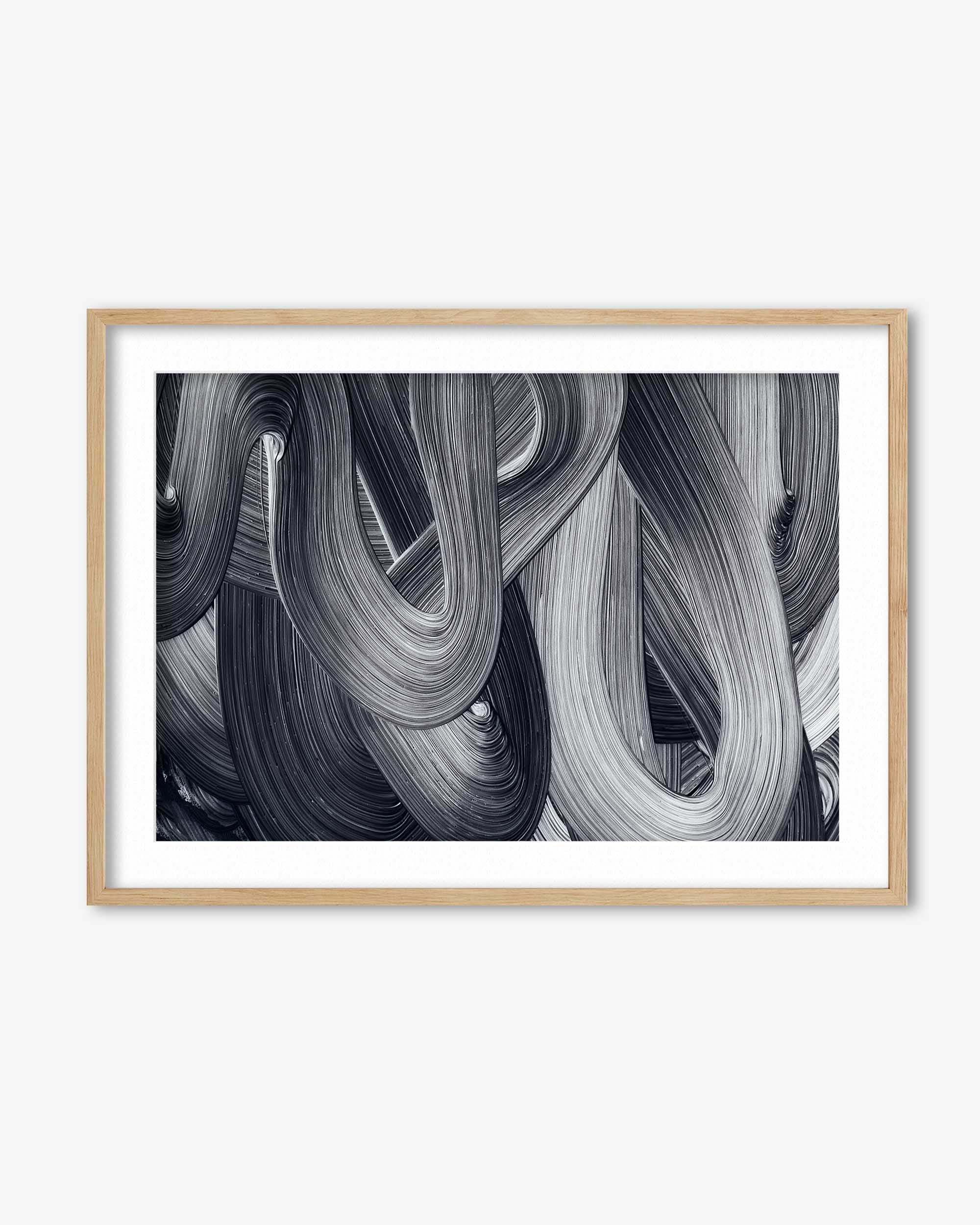 Framed abstract art print with black and white brush strokes on a white background
