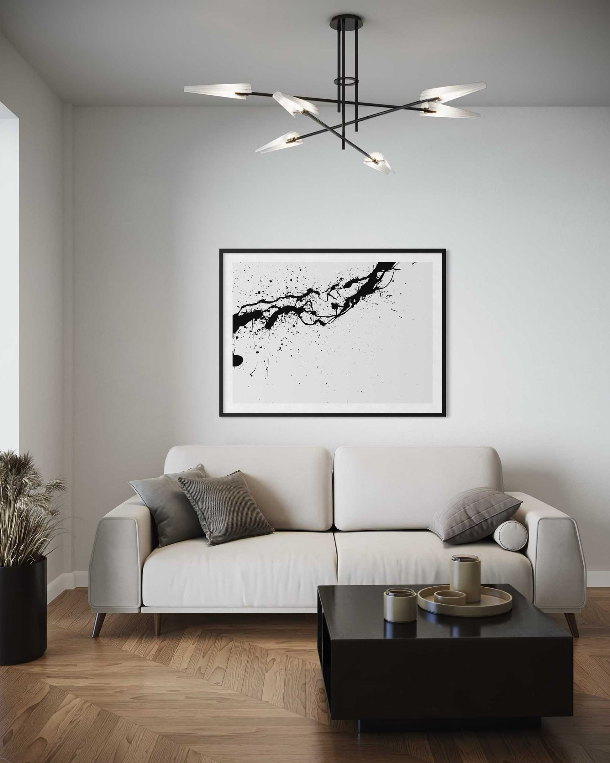 Modern living room with a white sofa, black coffee table, and abstract art on the wall.