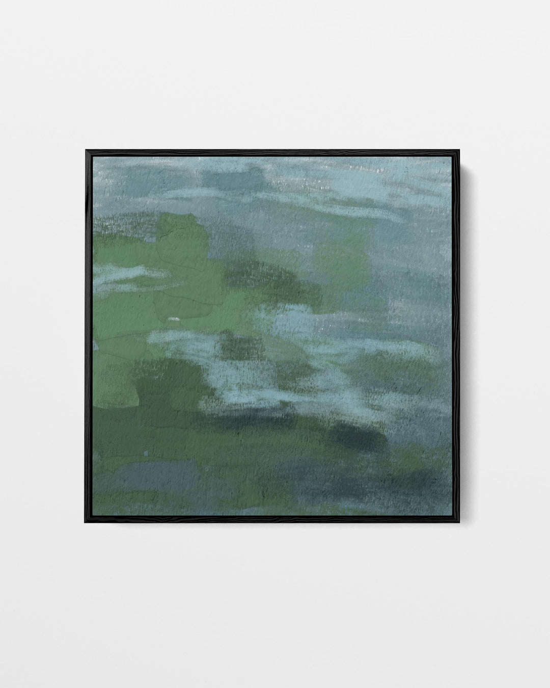 Framed abstract art with green and blue hues on a white wall