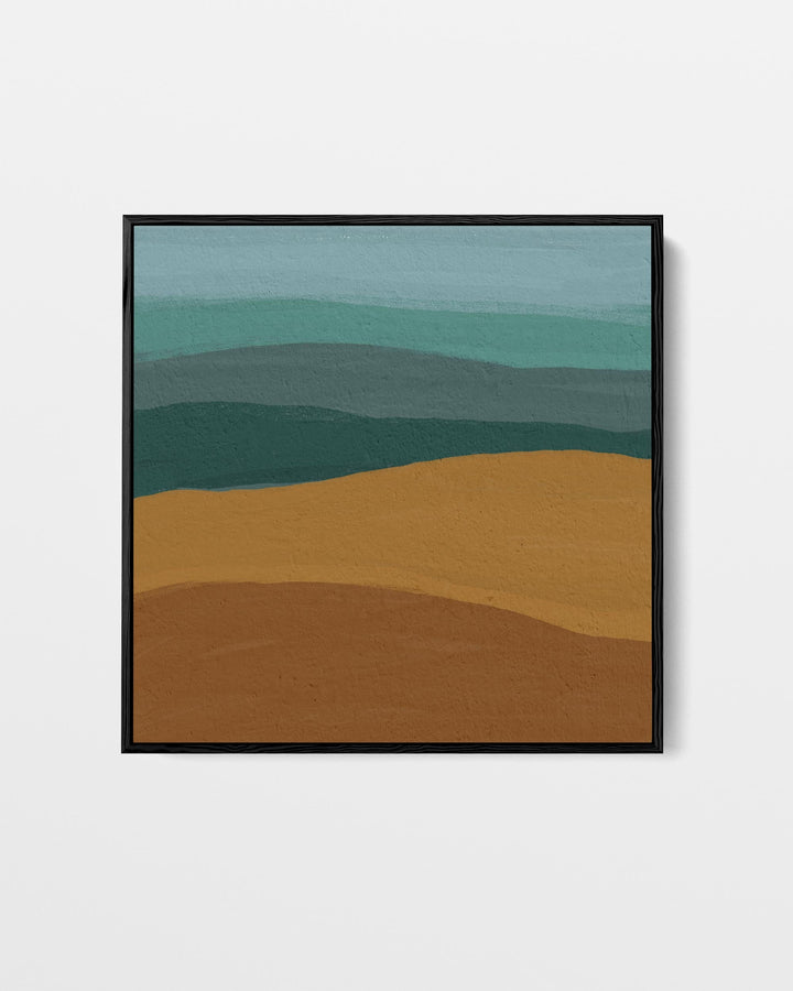 Framed abstract landscape art with green and brown hues on a white wall
