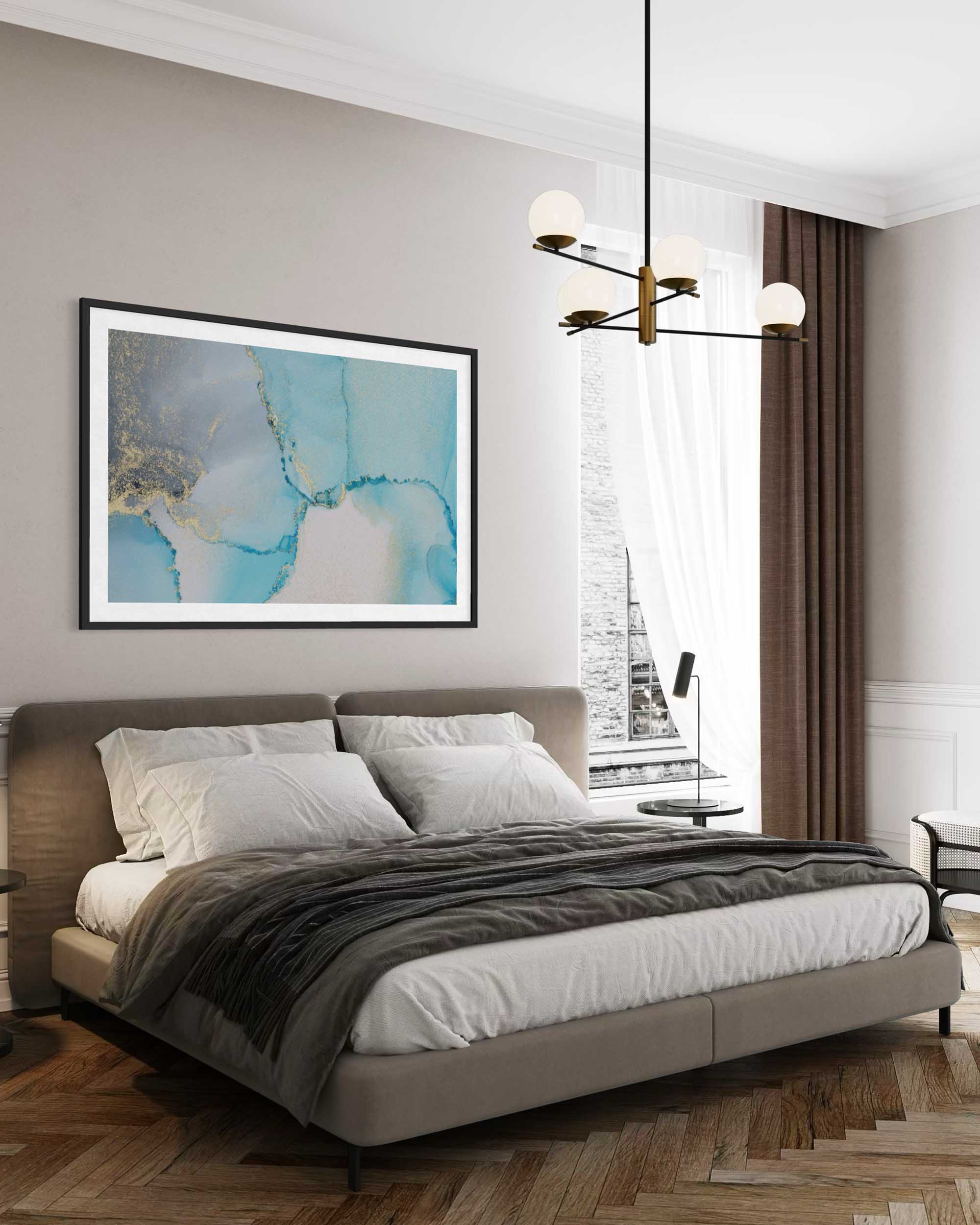 Modern bedroom with a bed, artwork on the wall, and a chandelier.