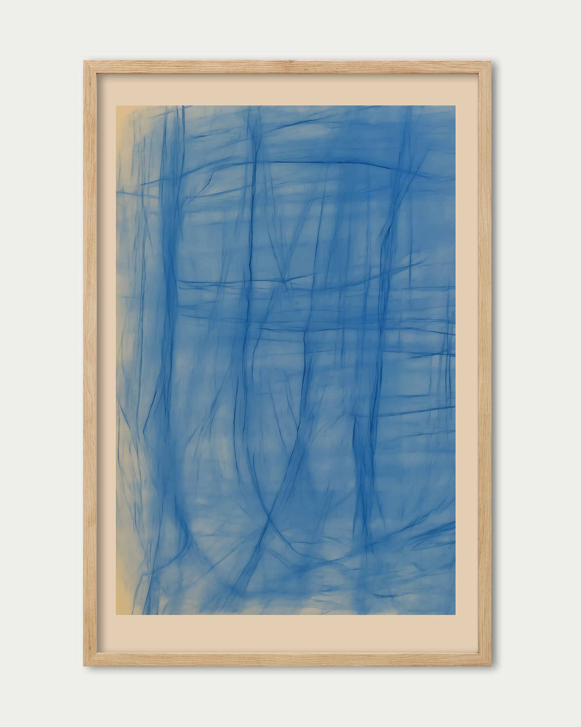 Framed abstract artwork with blue brush strokes on a white background