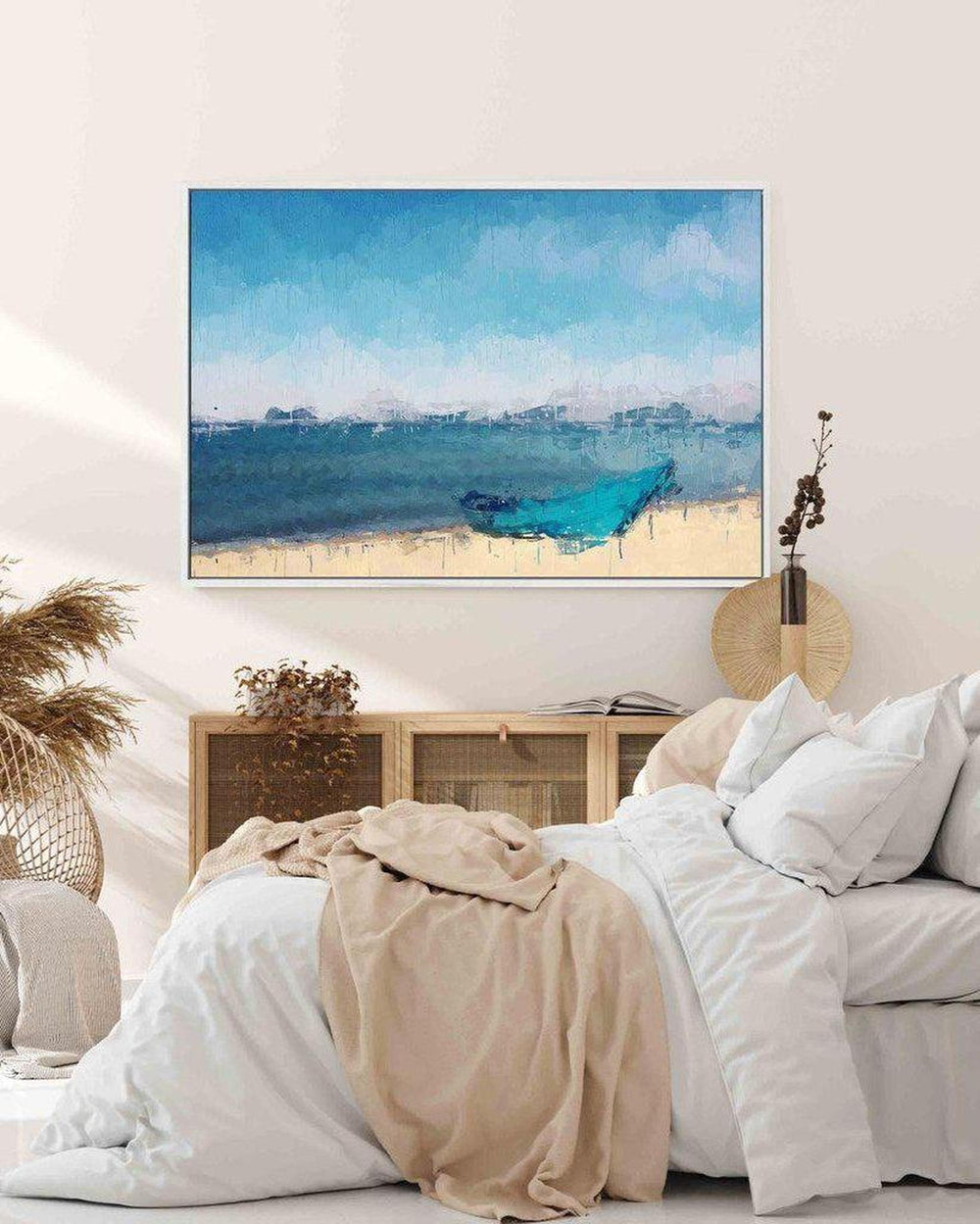 TV mounted on a wall above a bed with a scenic image of a blue boat on water.