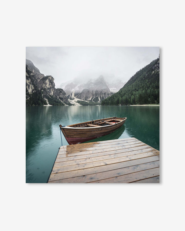 Wooden boat on a lake with mountains in the background