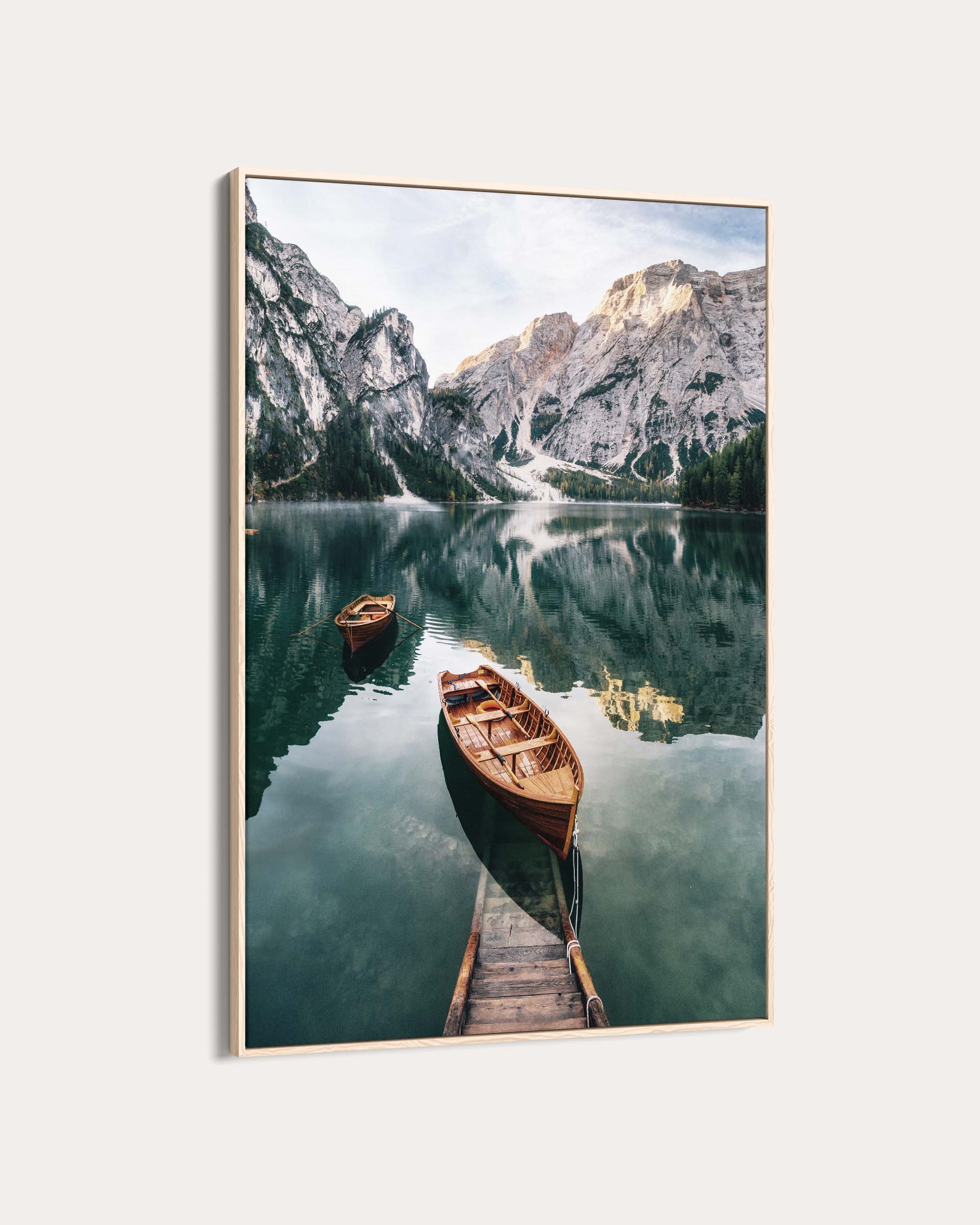 Framed photograph of a mountain lake with boats and a dock.