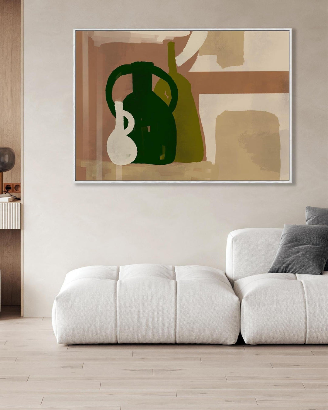 Modern living room with a white sofa, abstract art on the wall, and a side table.