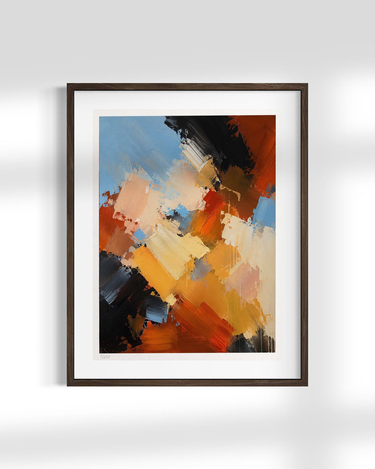 Framed abstract wall art featuring expressive brushstrokes in orange, blue, black, cream, and brown, displayed against a light gray wall.
