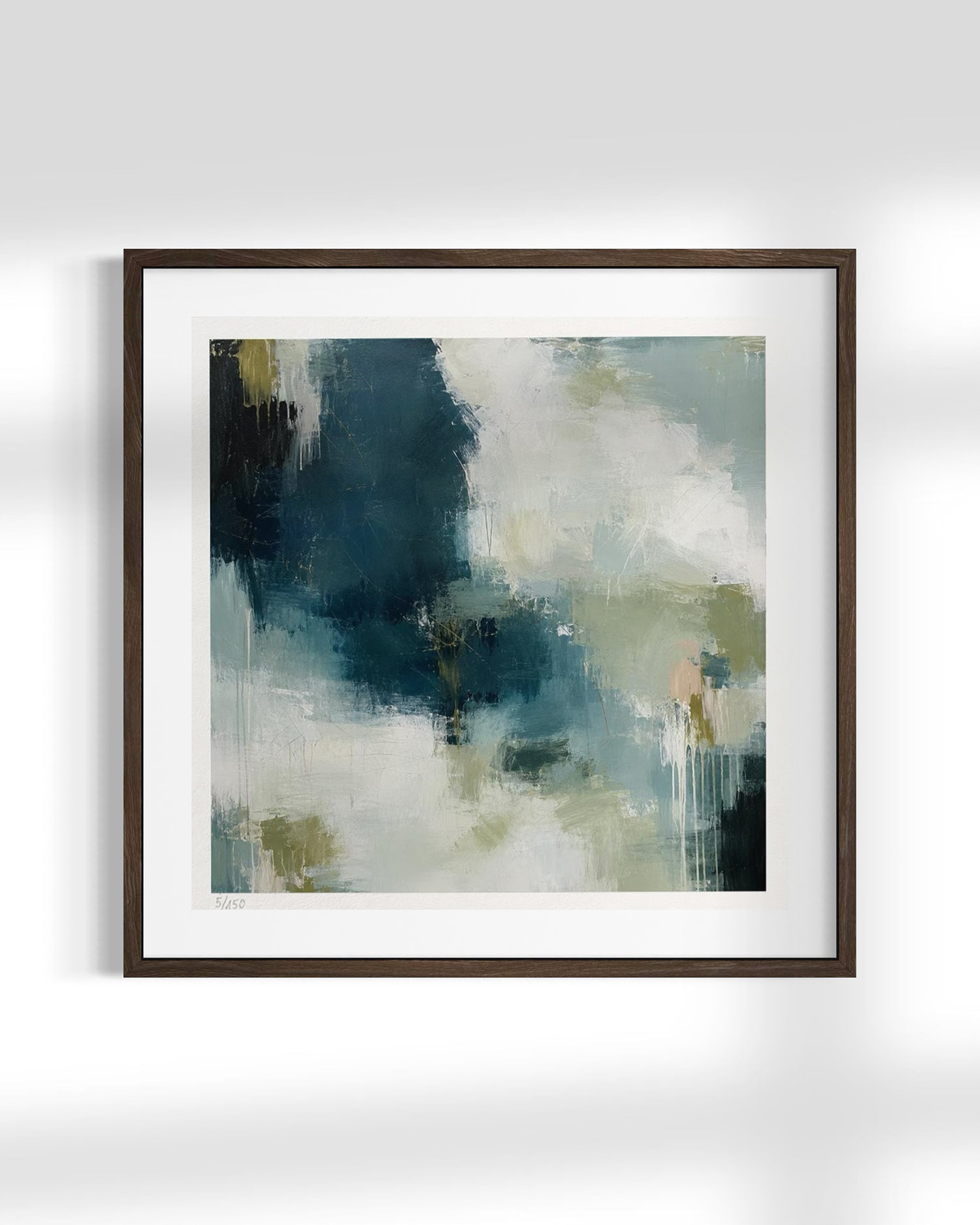 Framed abstract wall art featuring a textured painting with dark teal, slate blue, cream, and muted olive brushstrokes, presented in a dark brown frame with a white mat against a light gray wall.