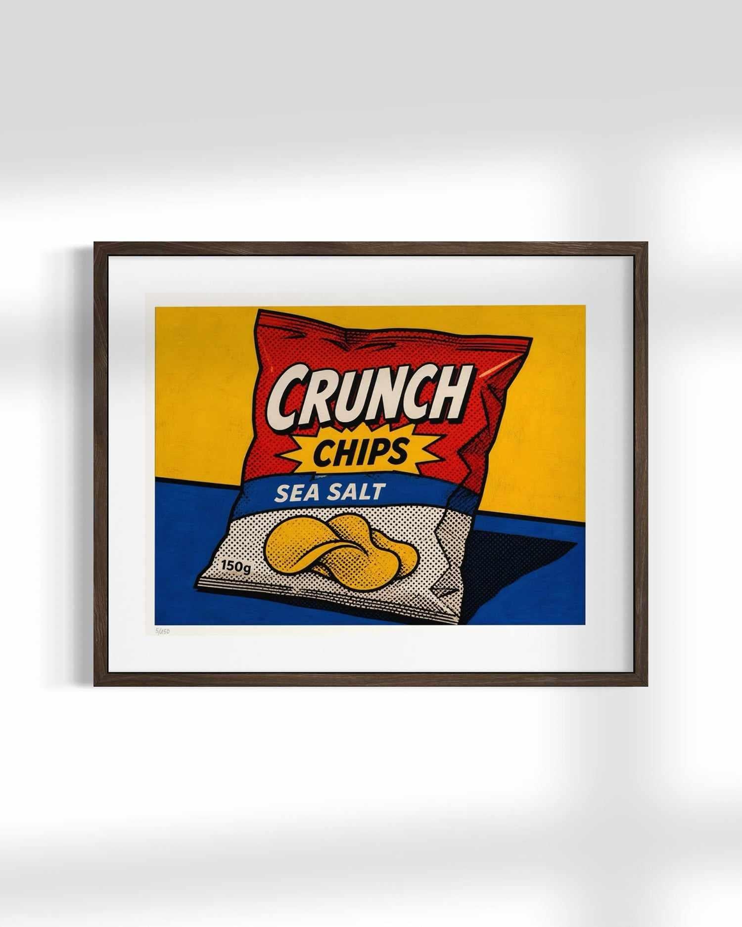 A framed pop-art style print of a Crunch Chips Sea Salt bag, shown hanging on a light gray wall with soft shadows.