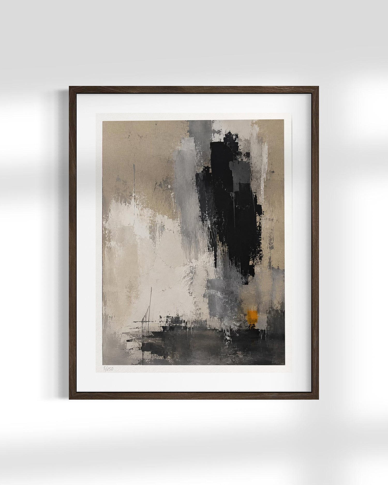 Framed abstract wall art featuring a modern composition of black, gray, beige, and white brushstrokes with a small orange accent, displayed in a dark wood frame against a light gray wall.