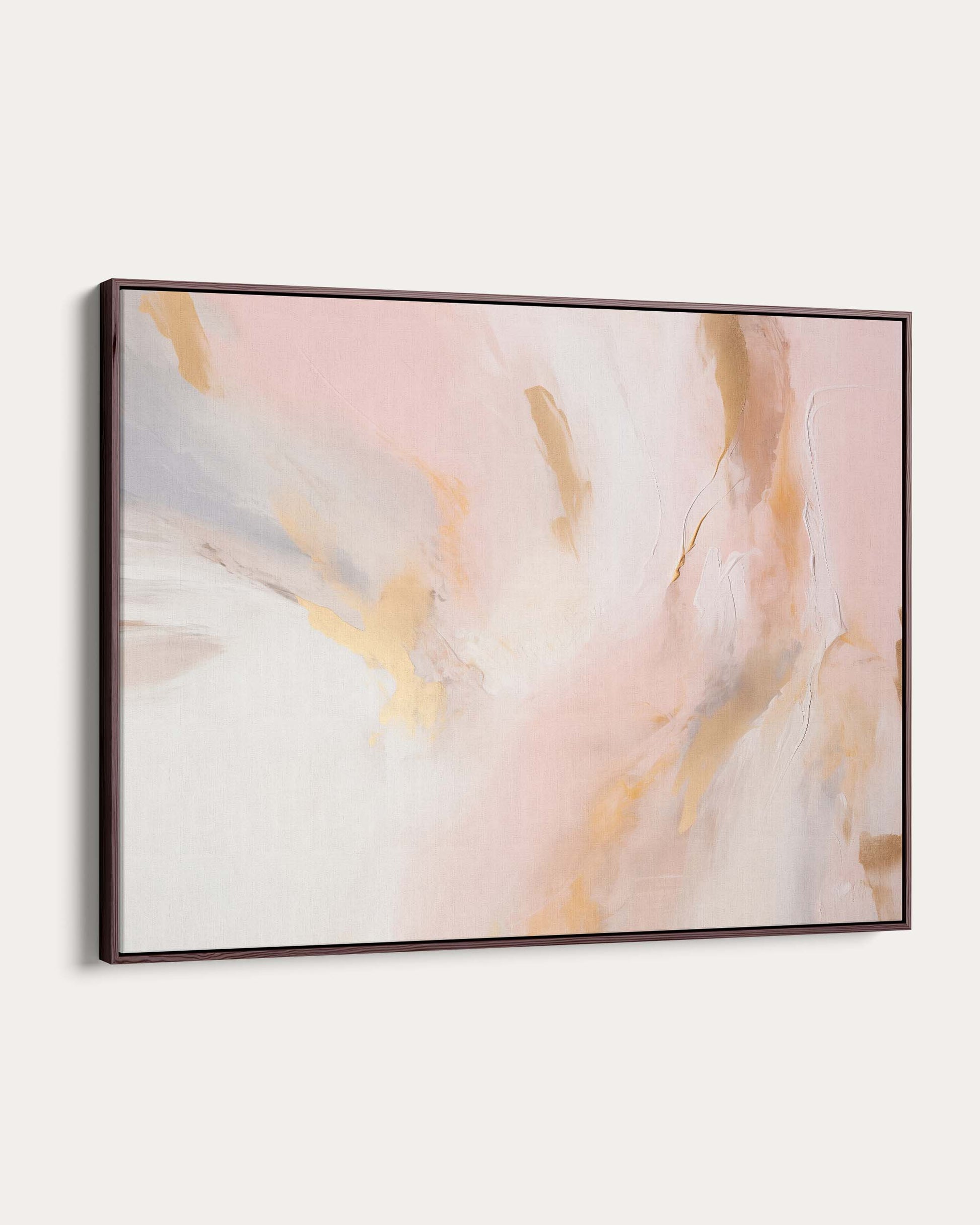 Abstract art piece with soft pink and gold colors on a white wall