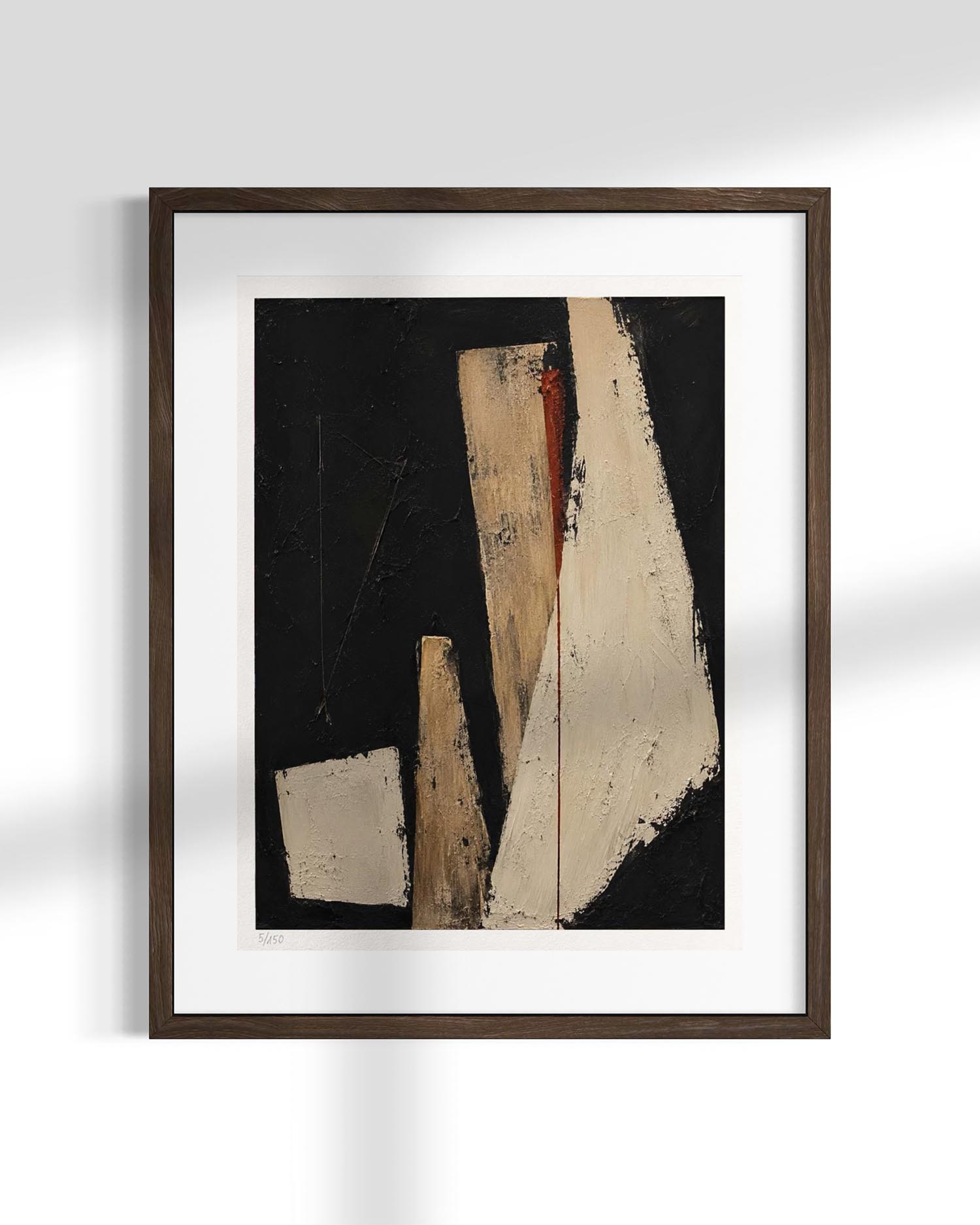 Framed abstract wall art featuring geometric shapes in beige, cream, and black, presented in a dark brown frame with a white mat against a light gray wall.
