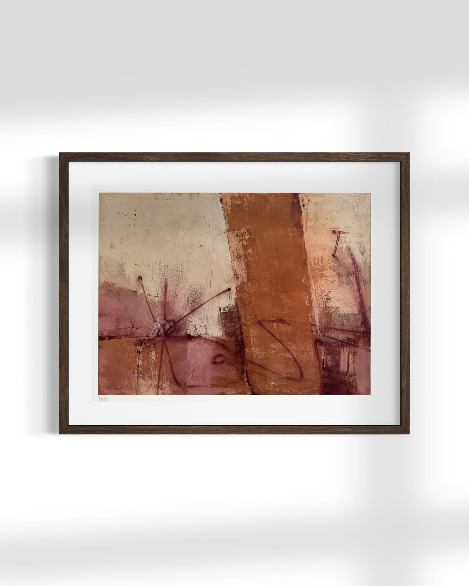 A framed abstract art print featuring textured brushstrokes in terracotta, rust, mauve, and beige tones, presented in a dark brown frame with a white mat against a light gray wall.