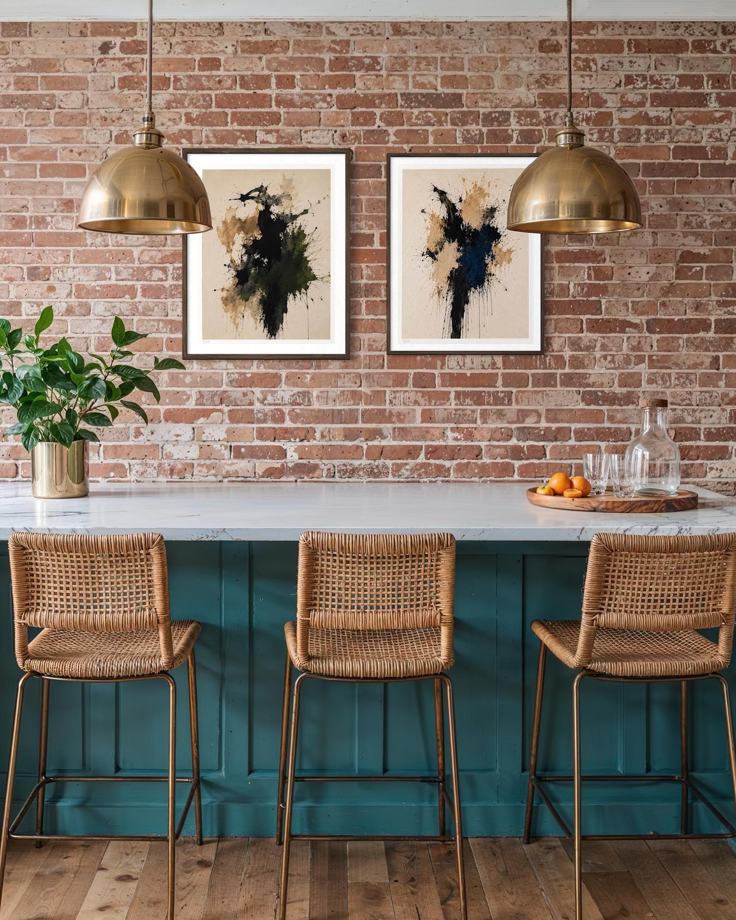 A styled interior scene with a teal bar counter, three woven wicker bar stools with gold metal legs, two brass pendant lights, a brick wall, and two framed abstract artworks above the counter.