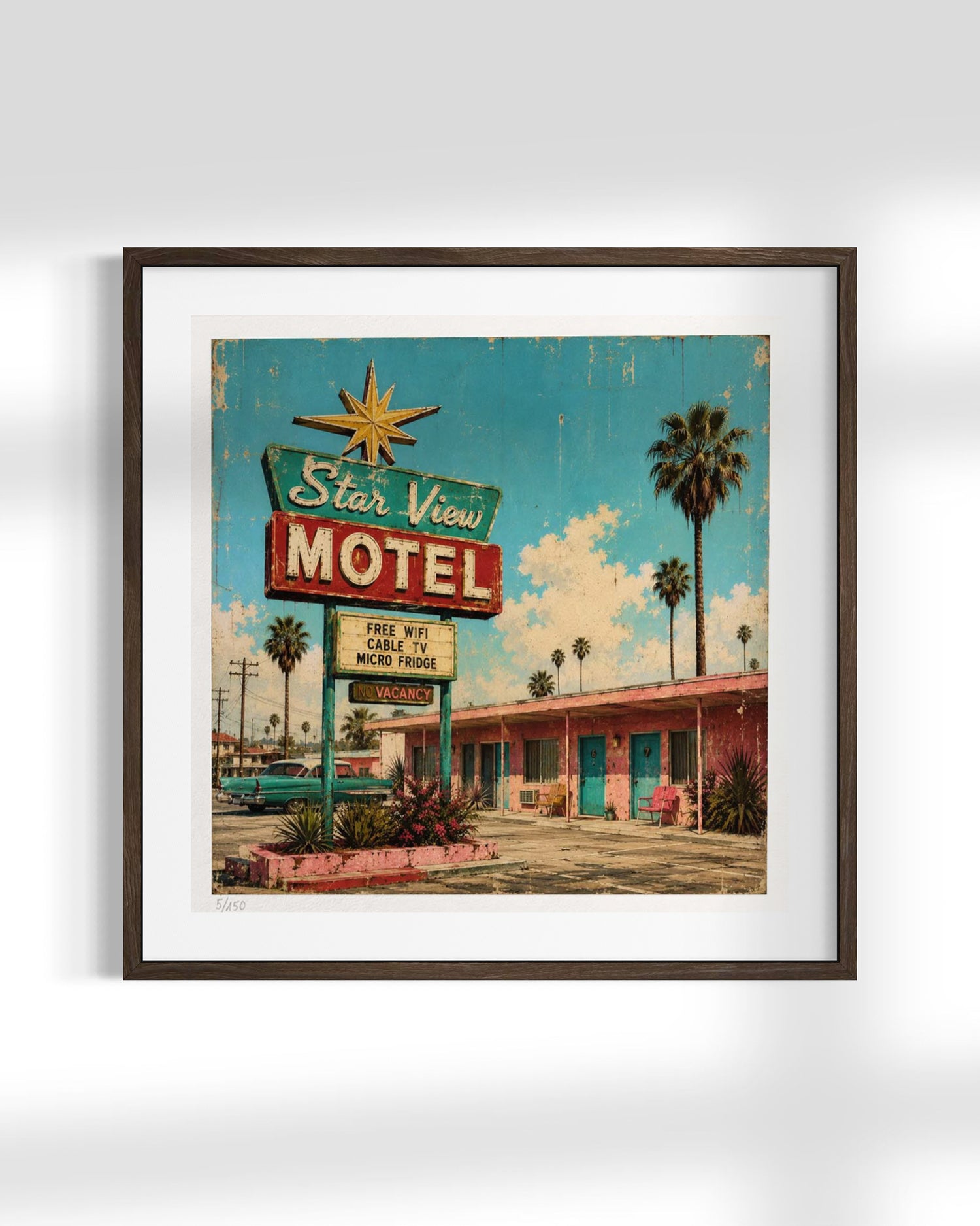 Framed wall art featuring a retro motel sign and motel building scene, shown in a dark wood frame with a white mat against a light gray background.