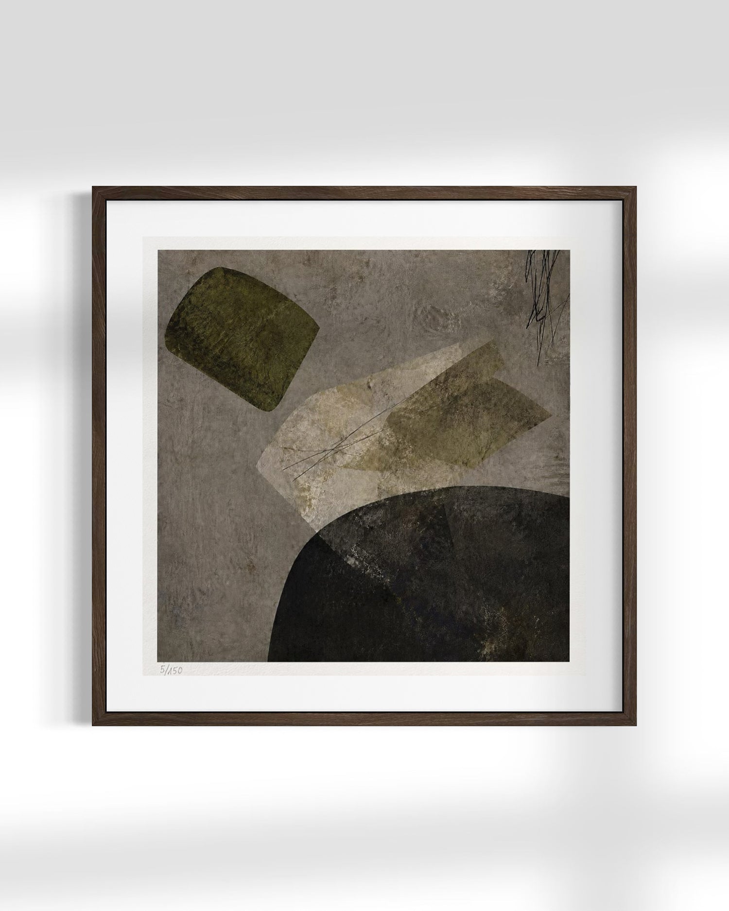 Framed abstract wall art featuring textured geometric shapes in olive green, beige, black, and gray tones, presented in a dark brown frame with a white mat against a light gray wall.