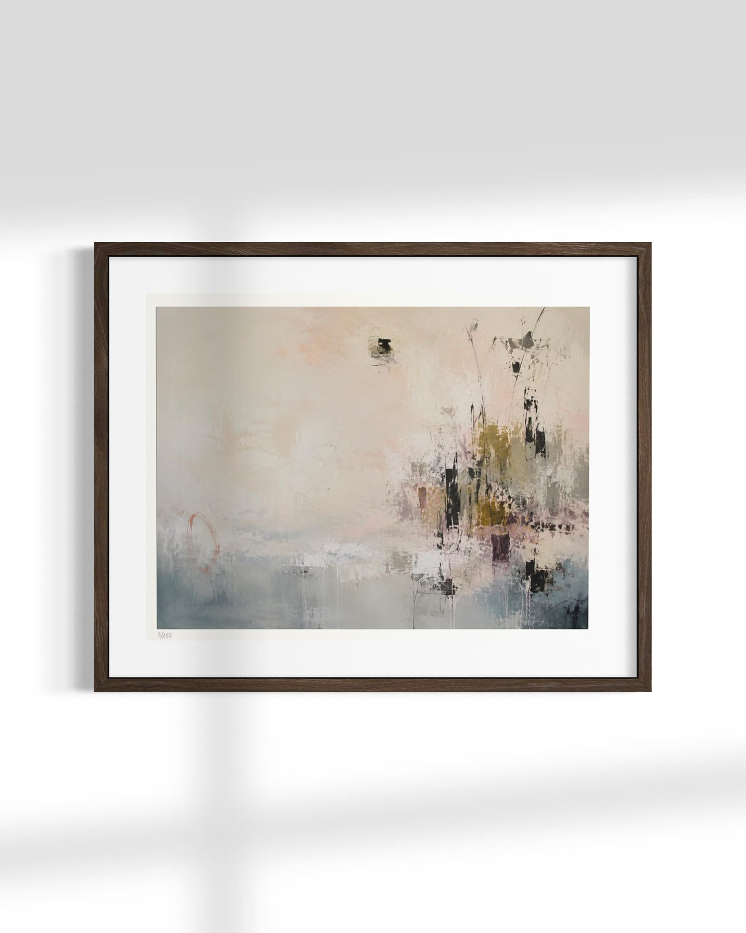 Framed abstract wall art hanging on a white wall, featuring soft blush, gray, blue, and olive tones with a dark brown wood frame and white mat.