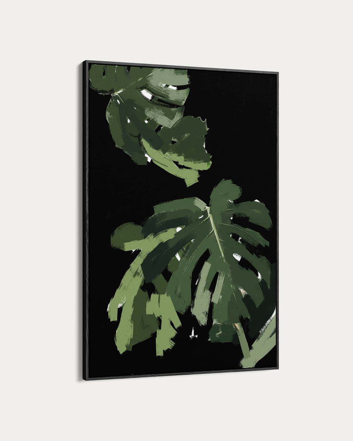 Framed artwork with green leaves on a black background