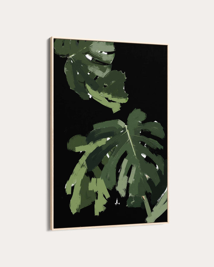 Framed artwork with green leaf design on a black background