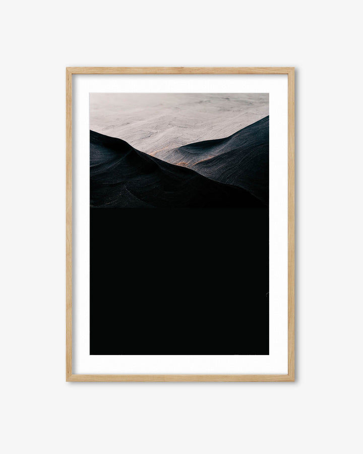 Framed artwork of a mountain landscape with a wooden frame on a white background