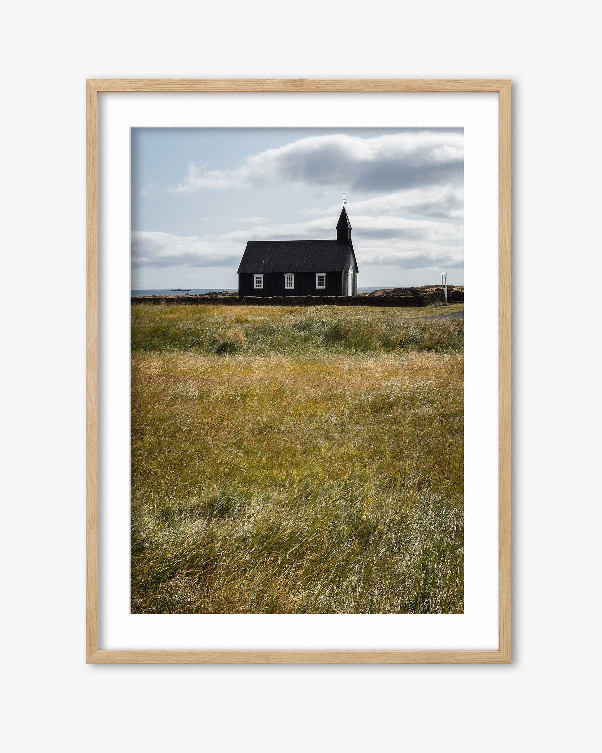 Framed photograph of a church in a field with a wooden frame