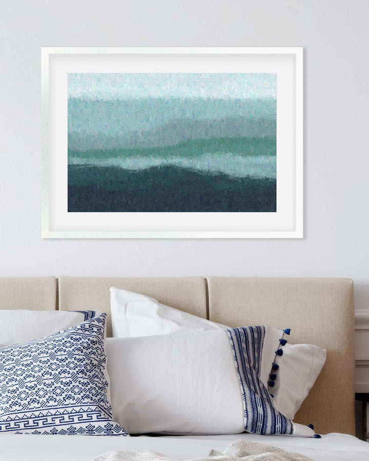 Framed abstract art above a bed with decorative pillows