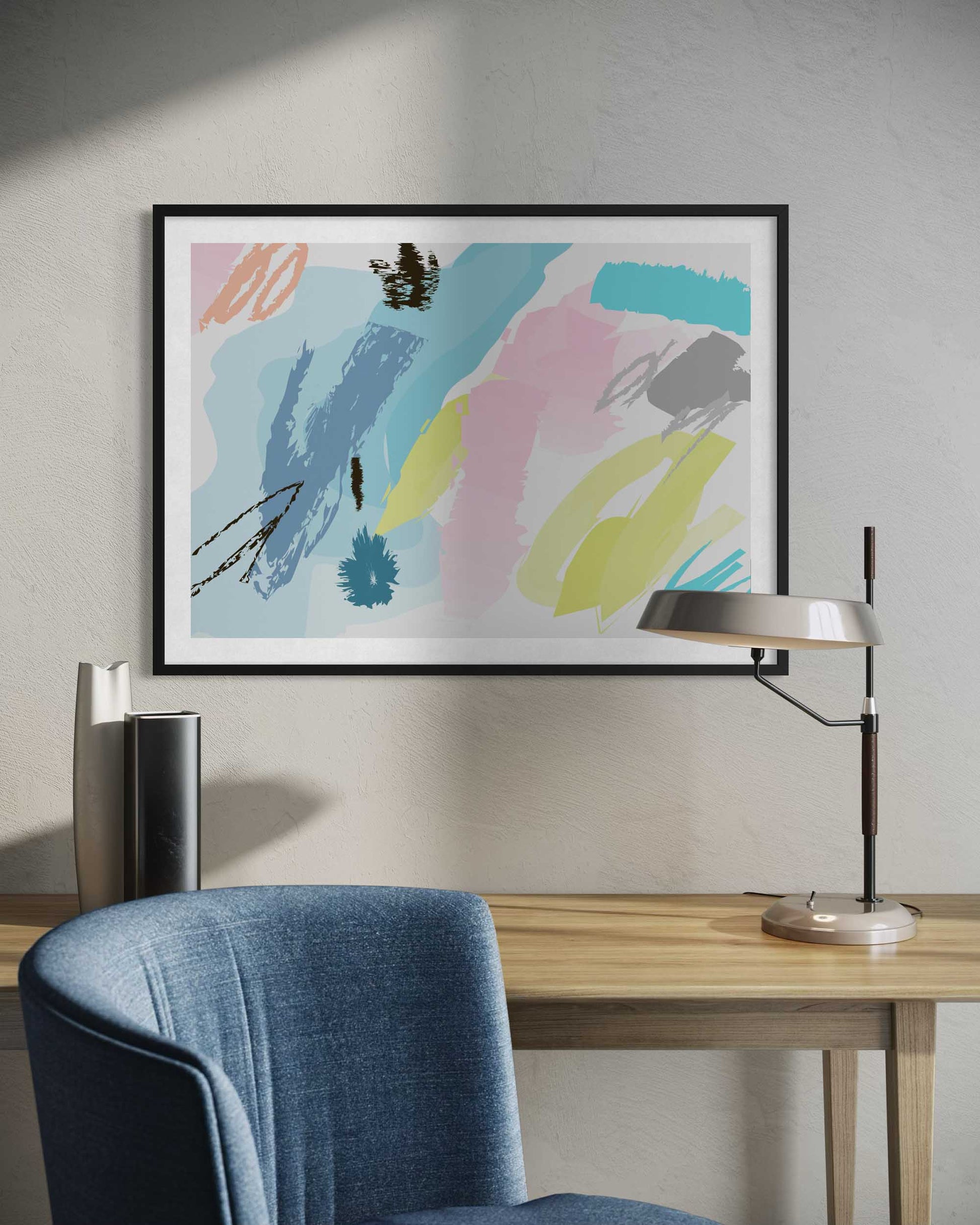 Abstract art print on a wall above a desk with a chair and lamp.