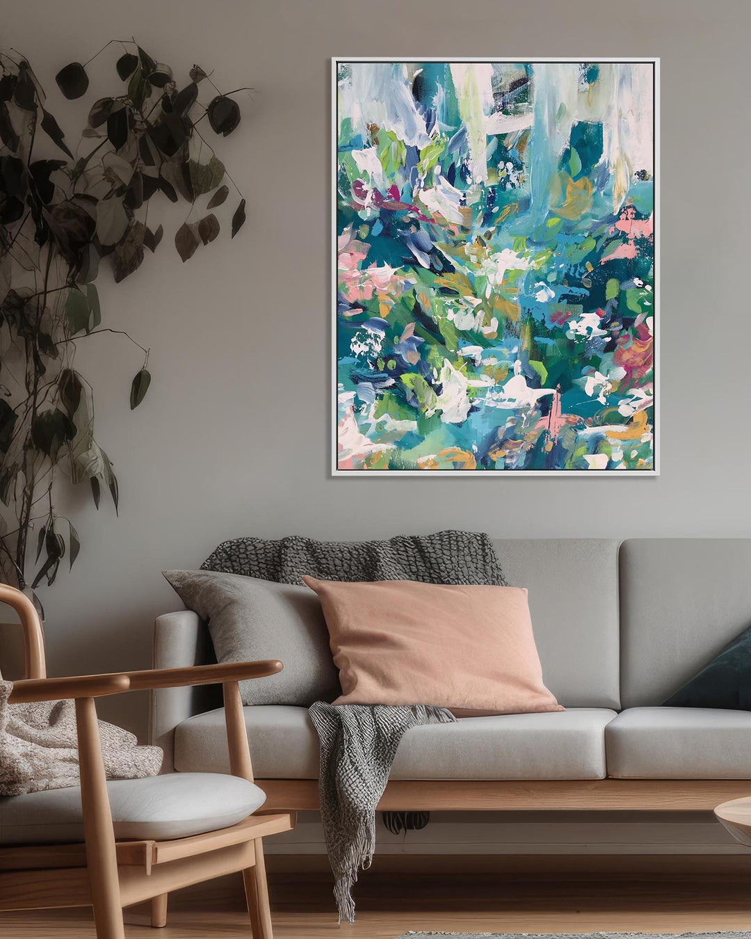 Living room with a gray sofa, wooden armchair, and abstract painting on the wall.