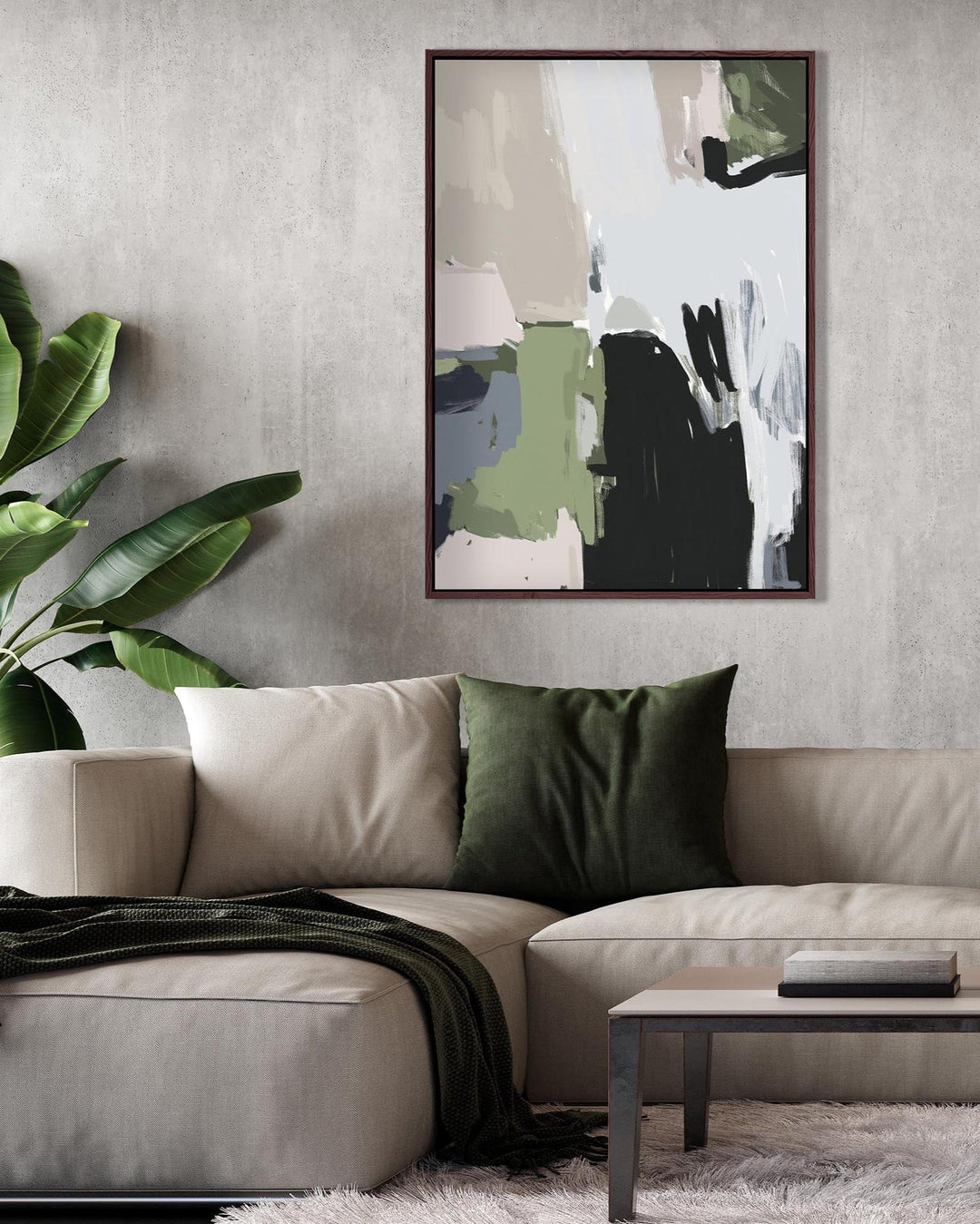 Living room with a beige sofa, green pillow, and abstract art on the wall.
