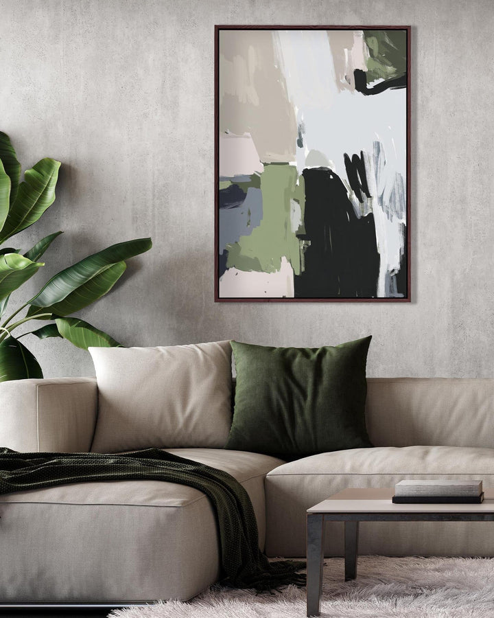 Living room with a beige sofa, green pillow, and abstract art on the wall.