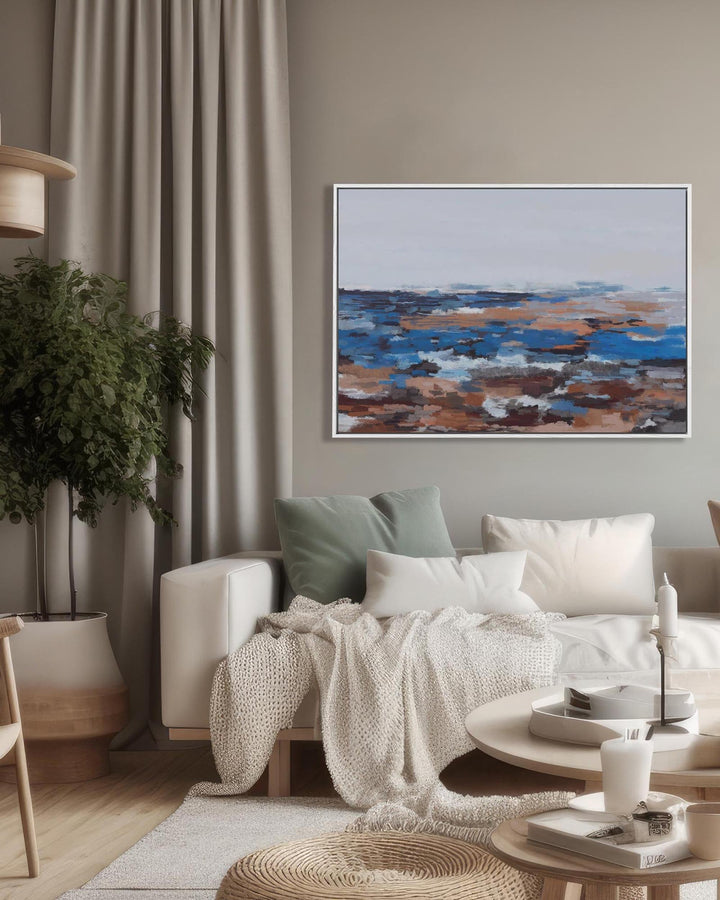 Living room with a sofa, coffee table, and abstract painting on the wall.