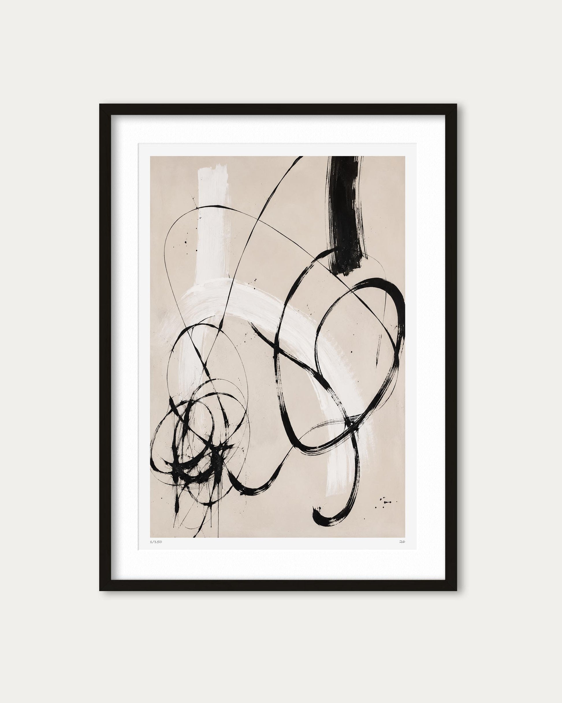 Abstract framed wall art featuring black and white expressive brushstrokes on a warm beige background, presented in a black frame with a white mat against a light gray wall.