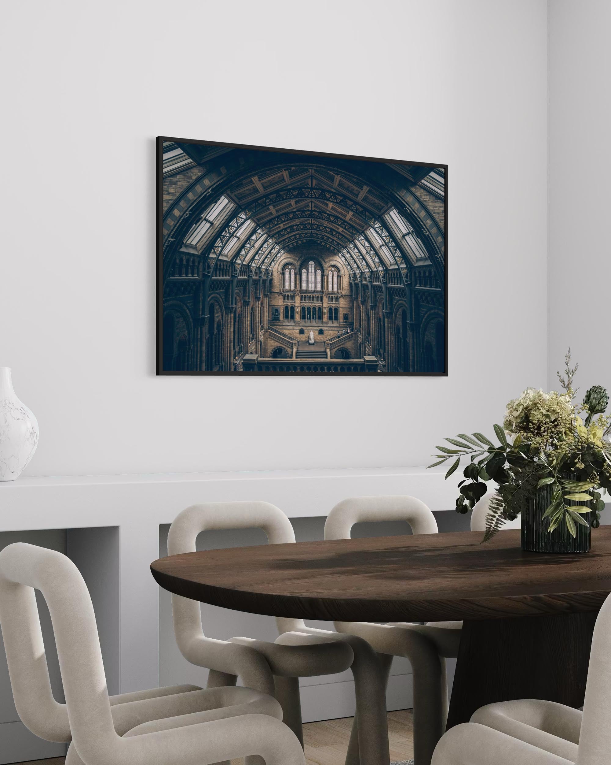 Dining room with a large framed photograph of a historic building on the wall.