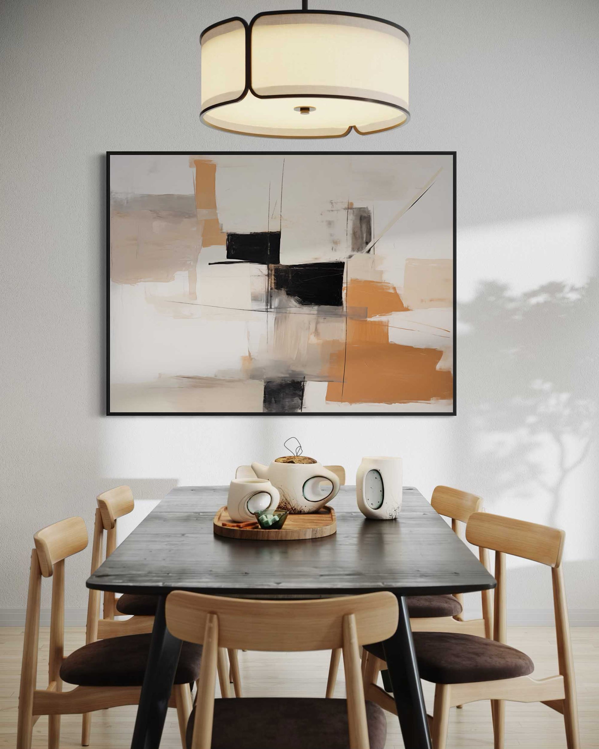 Dining room with a black table and wooden chairs, abstract art on the wall, and a chandelier.