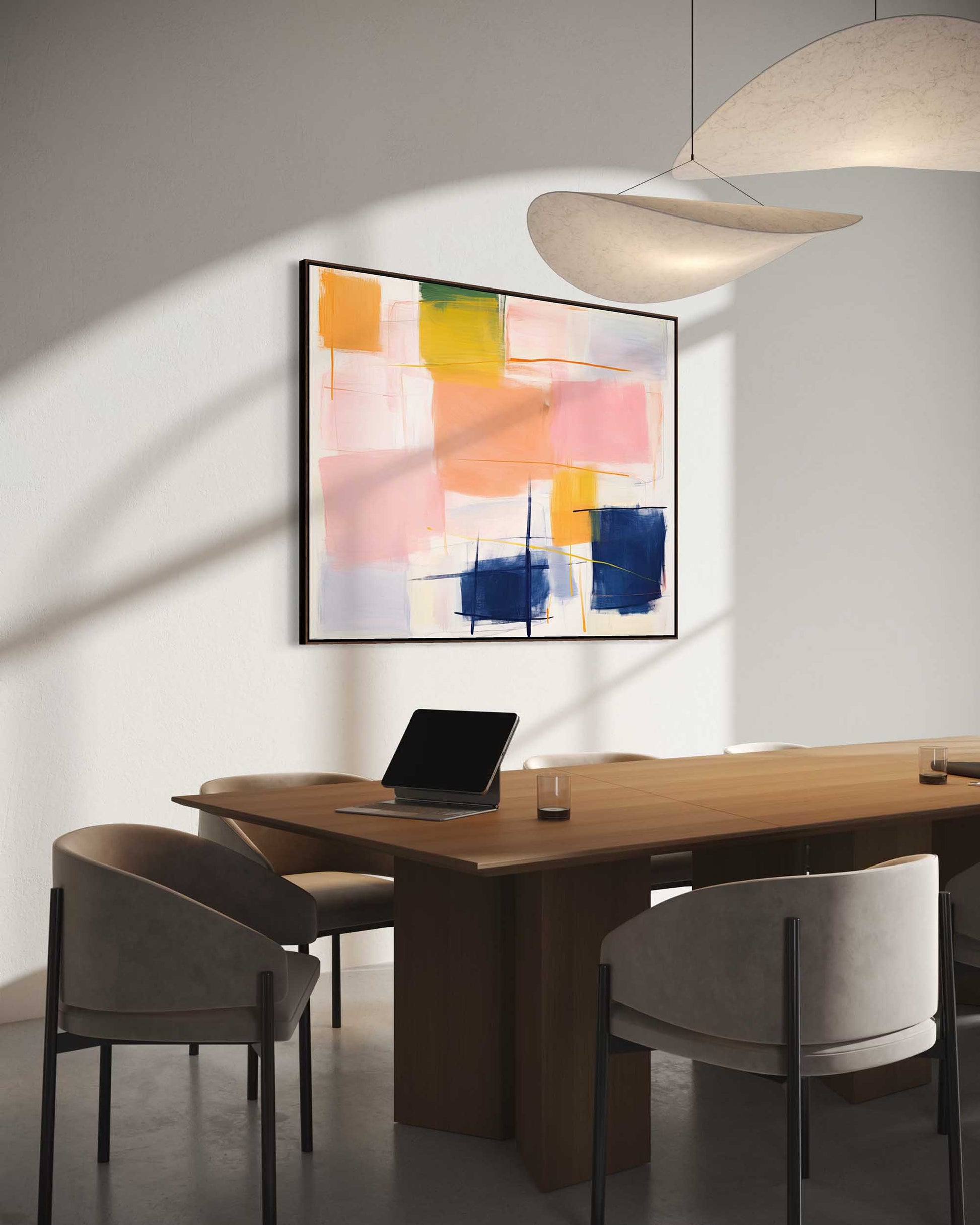 Modern office space with a wooden desk, chairs, and abstract art on the wall.