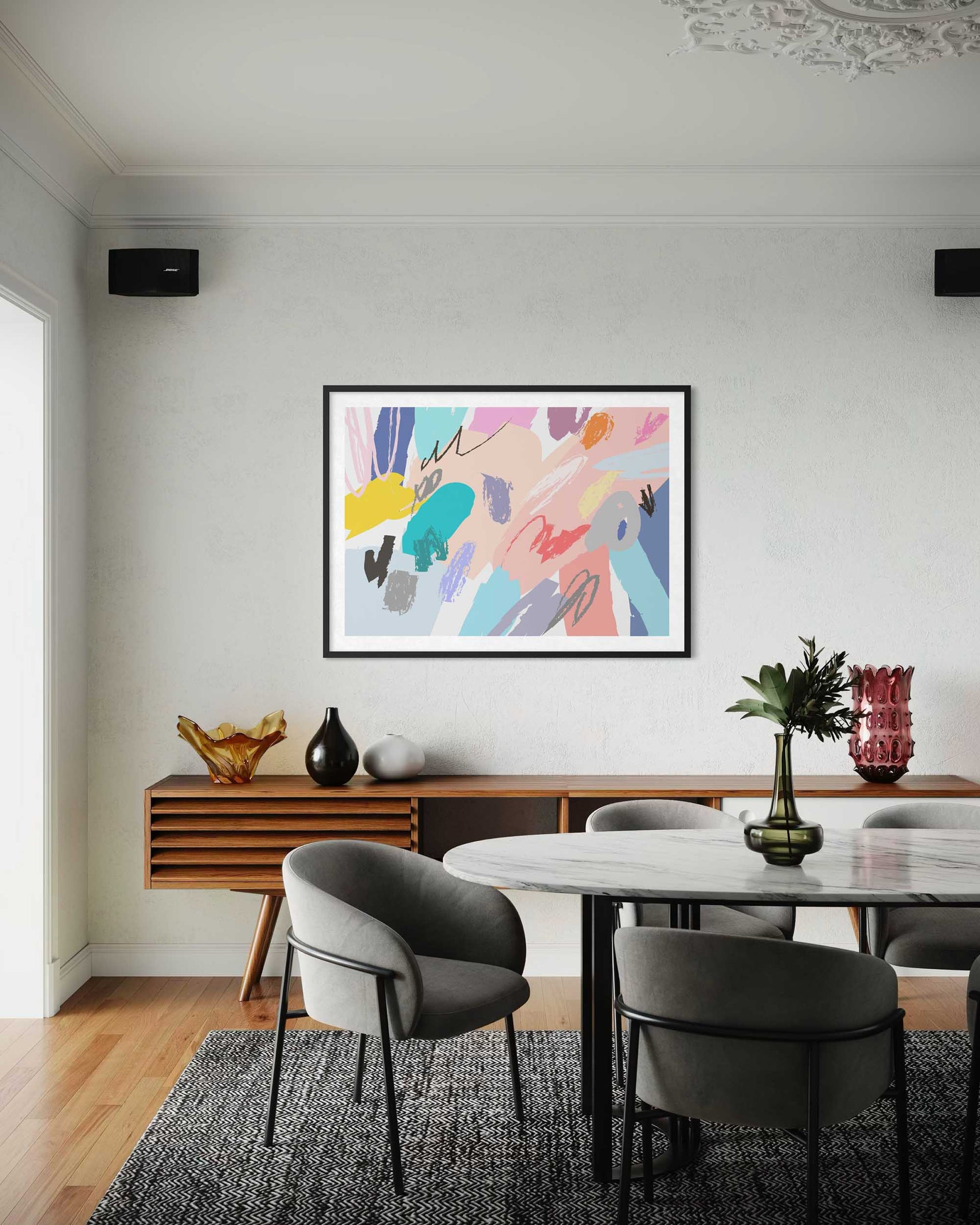 Dining room with a colorful abstract painting on the wall, wooden sideboard, and modern chairs.