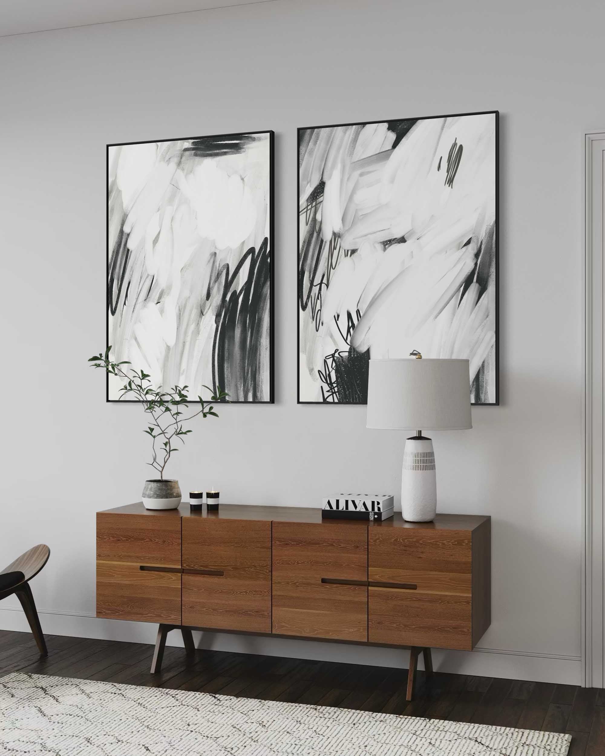 Wooden sideboard with abstract art on a white wall