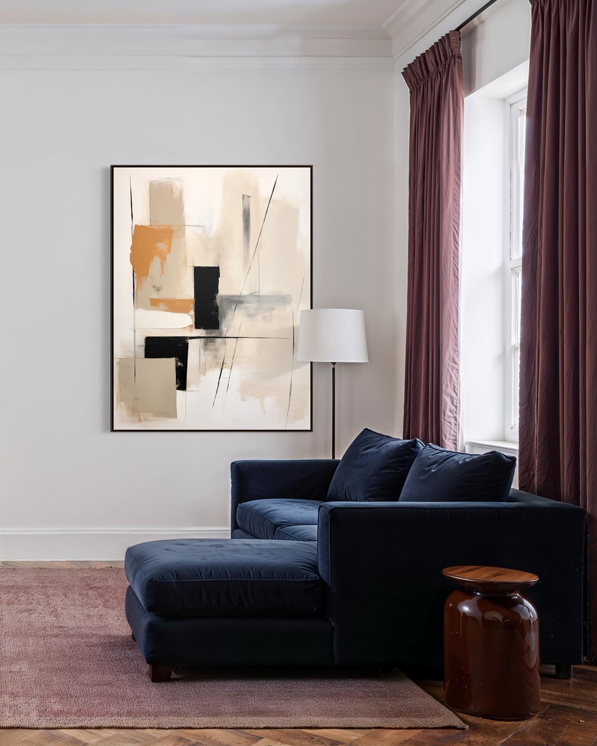 Modern living room with a navy blue sofa, abstract art, and a lamp.