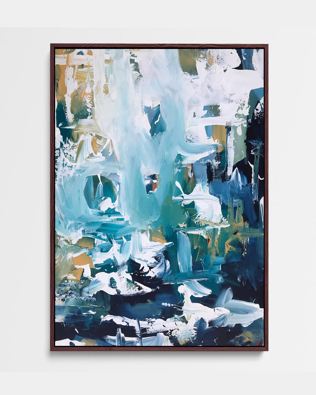 A framed canvas featuring an abstract blue artwork with white and green accents, presented in a brown frame.