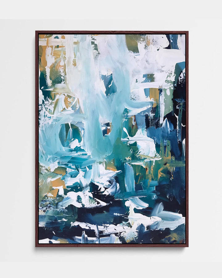 A framed canvas featuring an abstract blue artwork with white and green accents, presented in a brown frame.