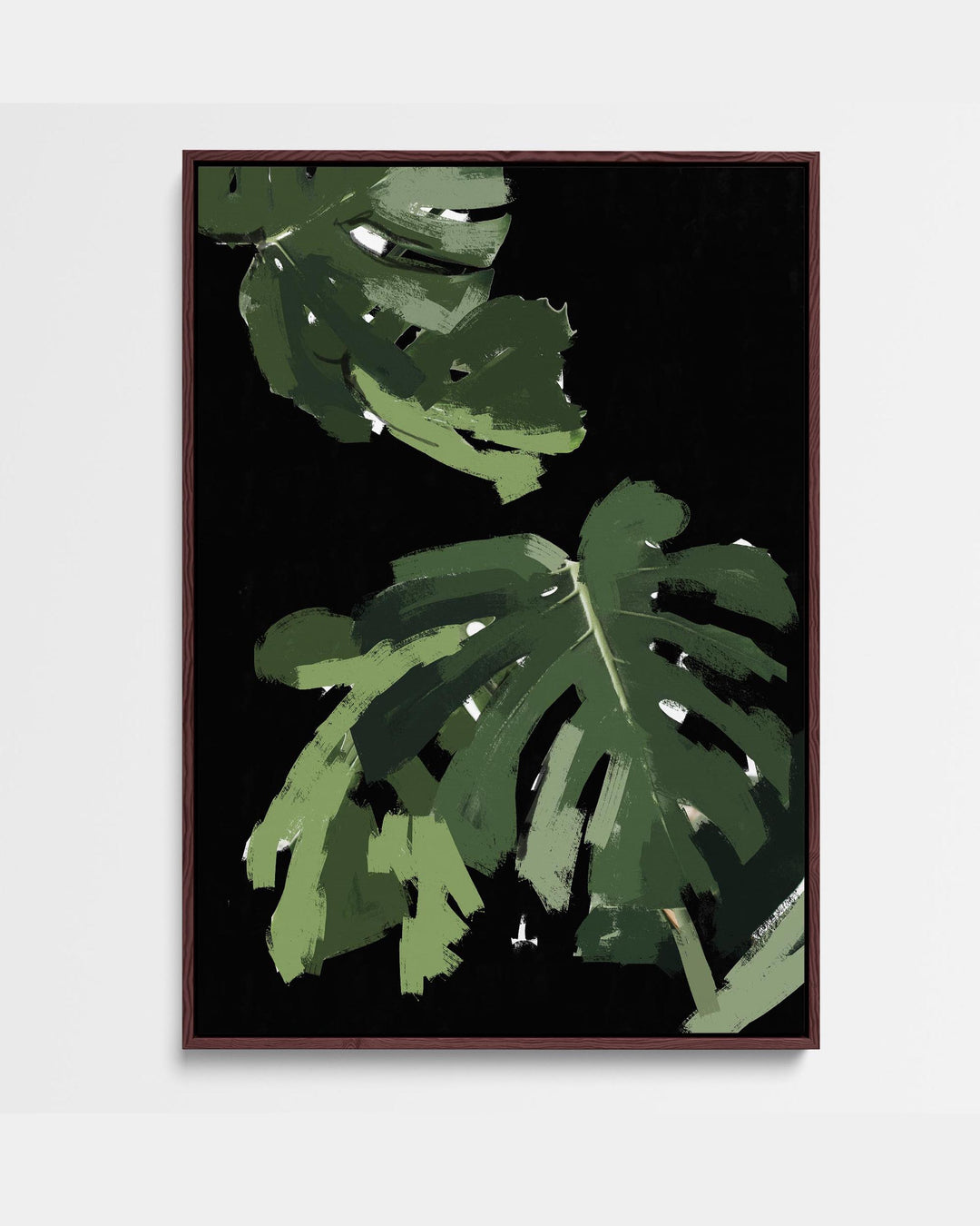 A framed canvas artwork depicting a monstera leaf with a black background and green accents, presented in a portrait orientation.