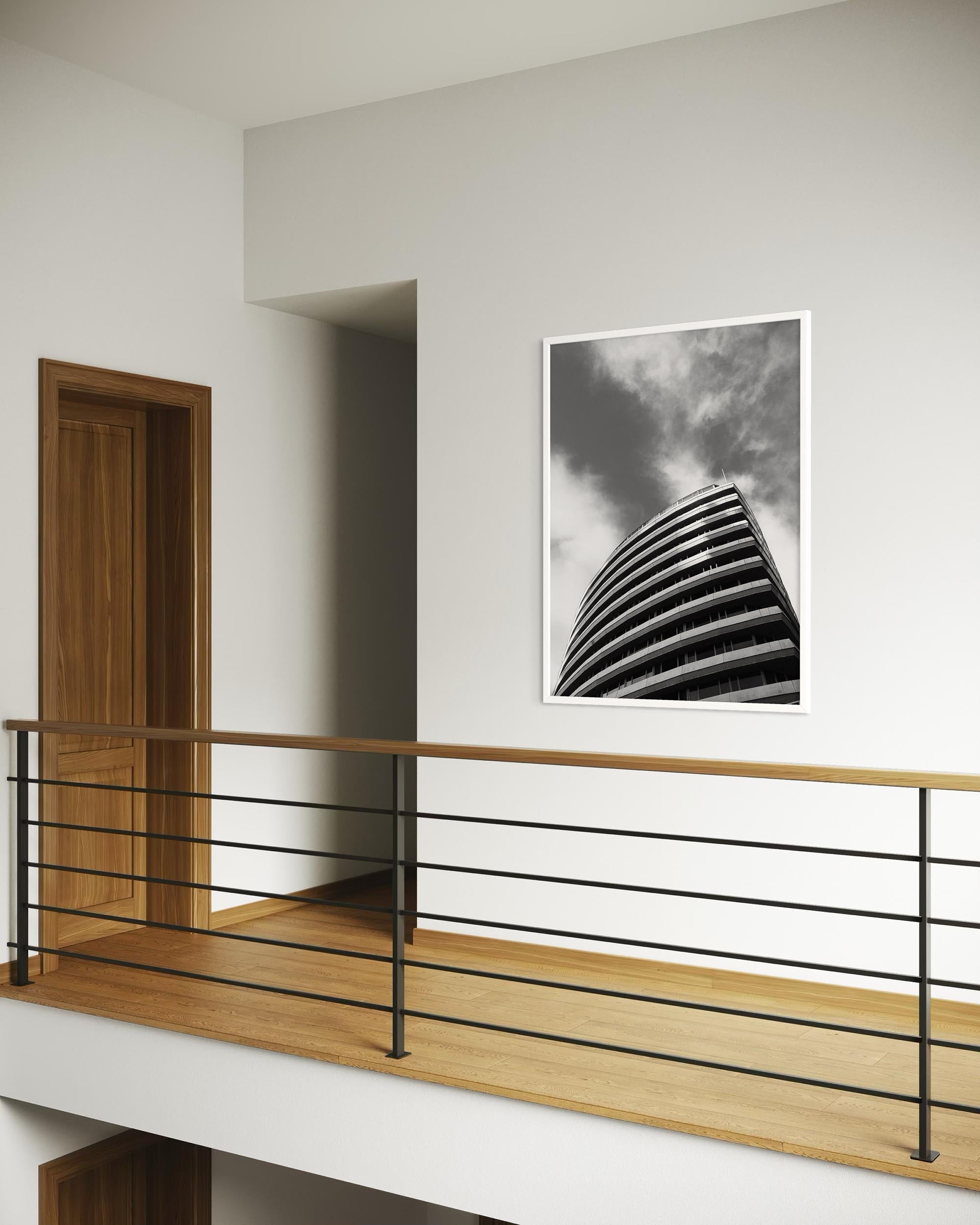Modern interior with a staircase and a framed black and white artwork on the wall.