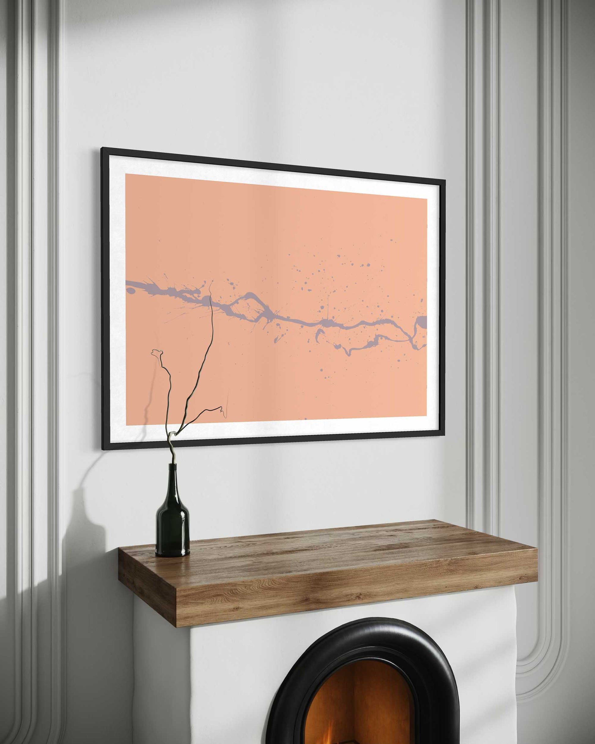 Framed map on a wall above a wooden shelf with a black vase.